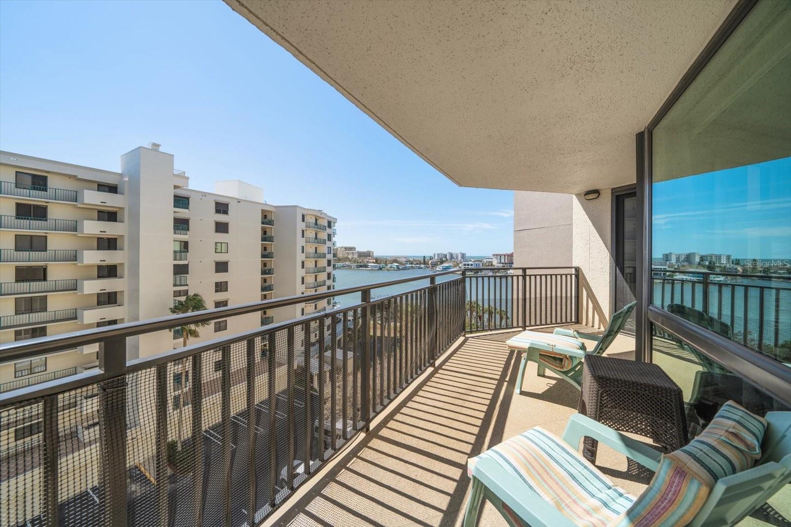 Sliding glass doors from primary bedroom lead to balcony