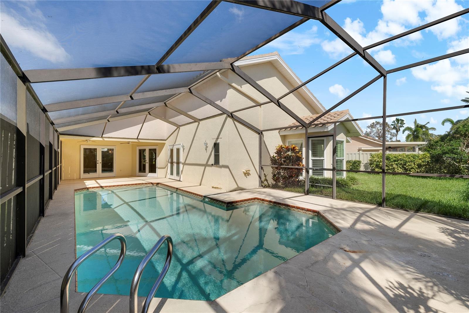 Plenty of space for sun and shade with additional grassy space outside of the pool lanai.