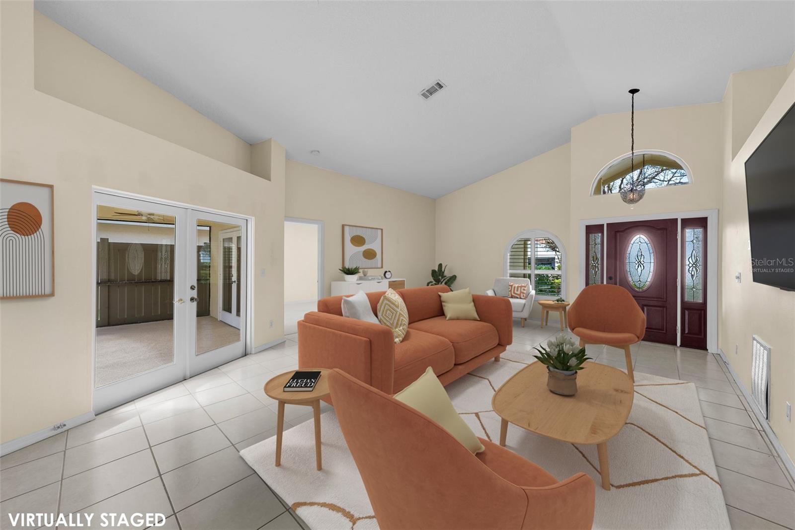 Virtually staged. French doors from the living room lead to the sparkling pool.