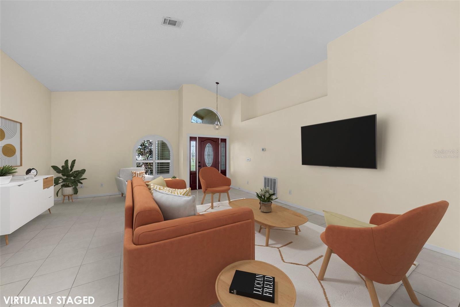 Virtually staged living room and front entry.