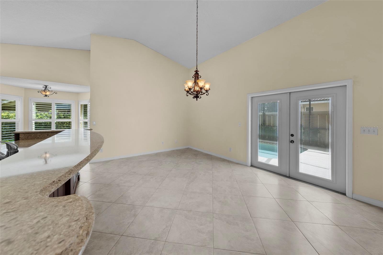 Additional French doors lead to the pool area.