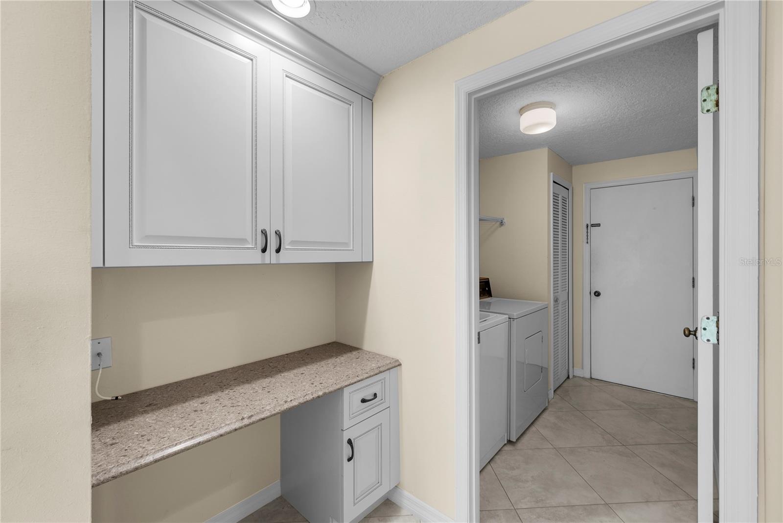 Built-in desk space leading to the laundry room.