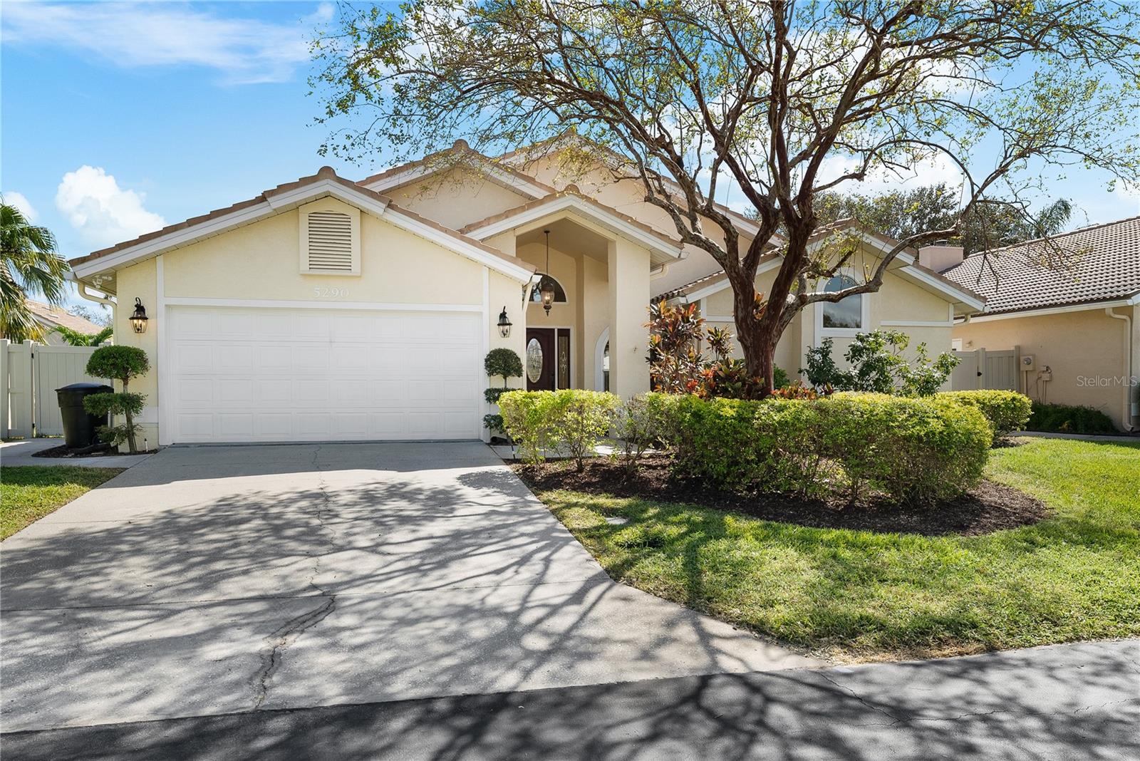 Two car garage with a large driveway.