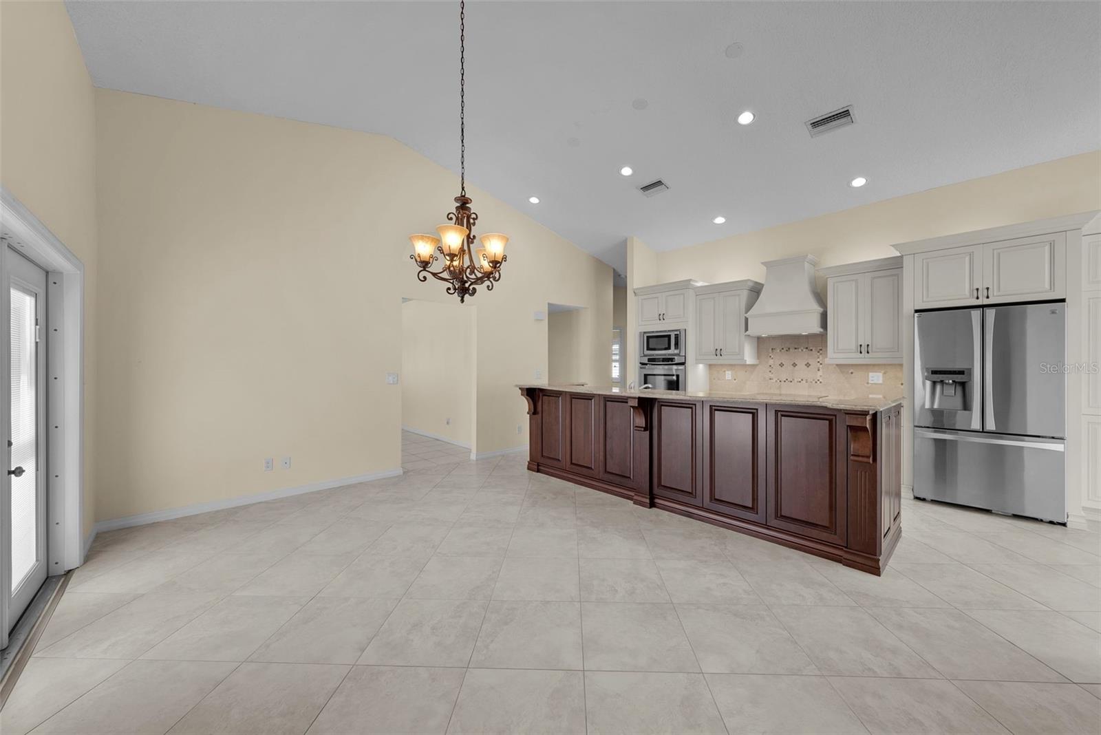 The space for the dining room table could easily be used as a second TV room.