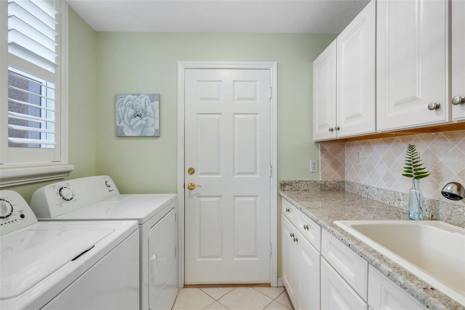 Washer and dryer convey in this inside laundry room!