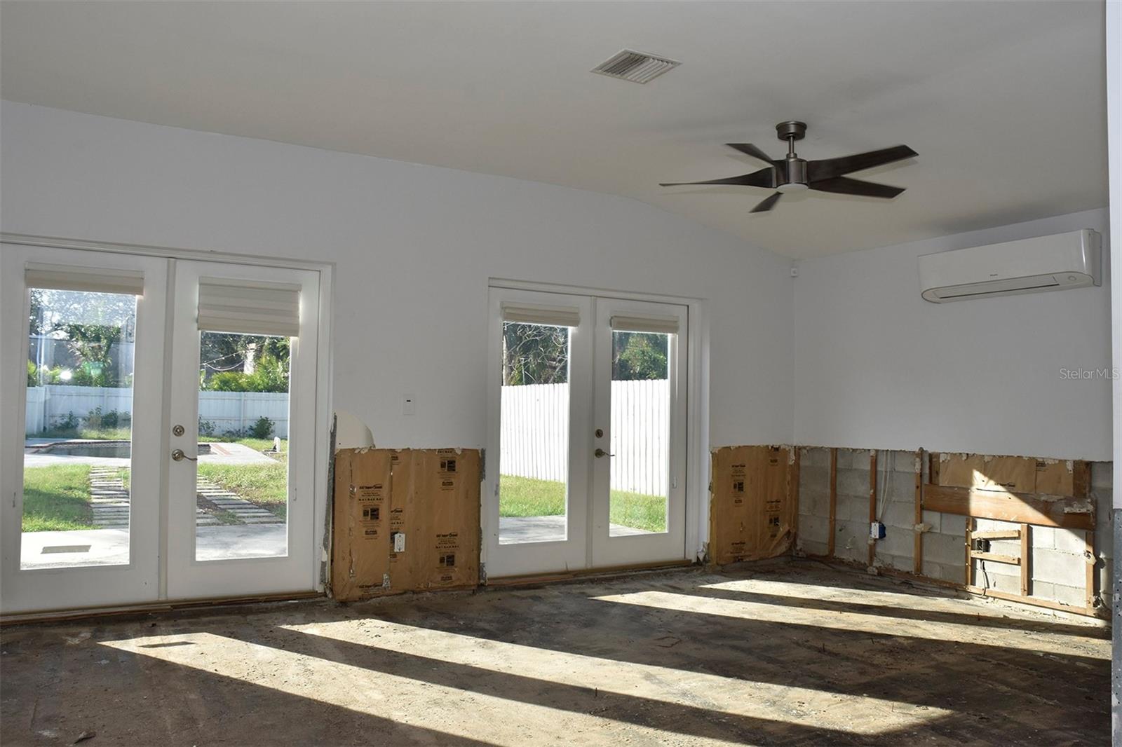 View from the kitchen towards the French doors that lead to the backyard and pool. Post-flood.