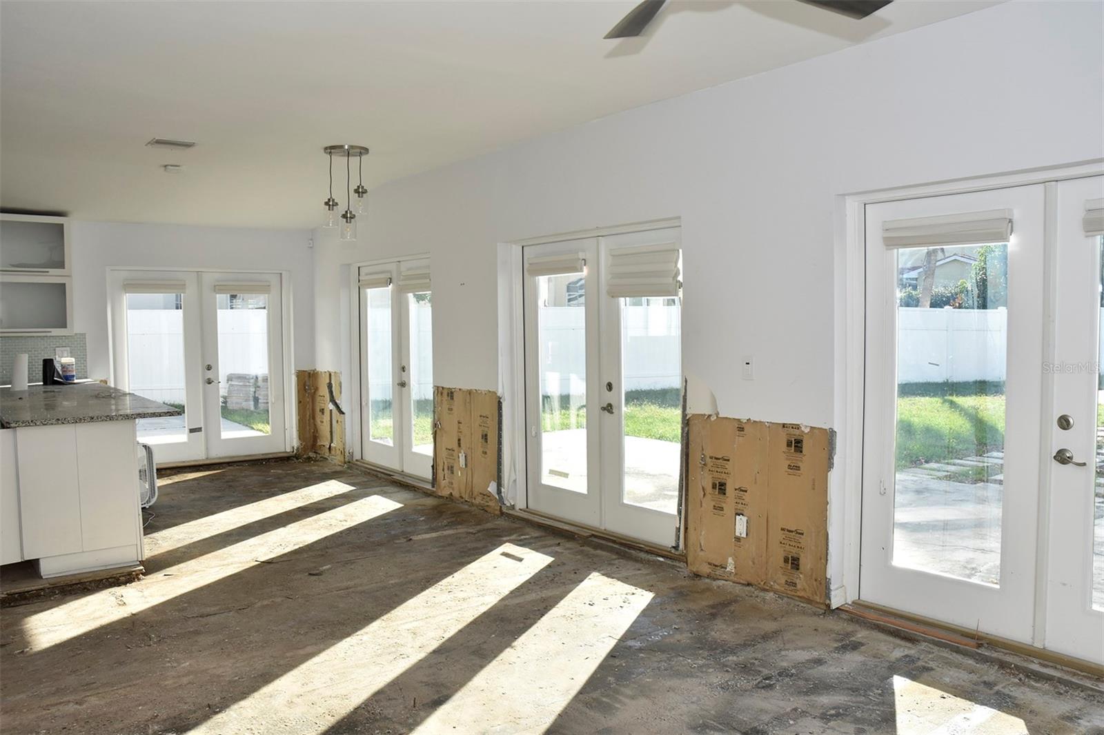 There are four sets of french doors leading out to the backyard. Post-flood image.