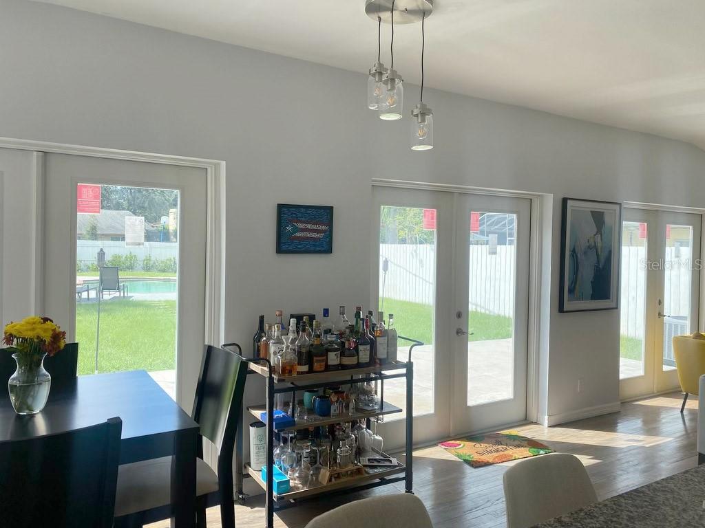 View from the kitchen area. French doors lead out to the backyard and pool. Photo taken before flooding.