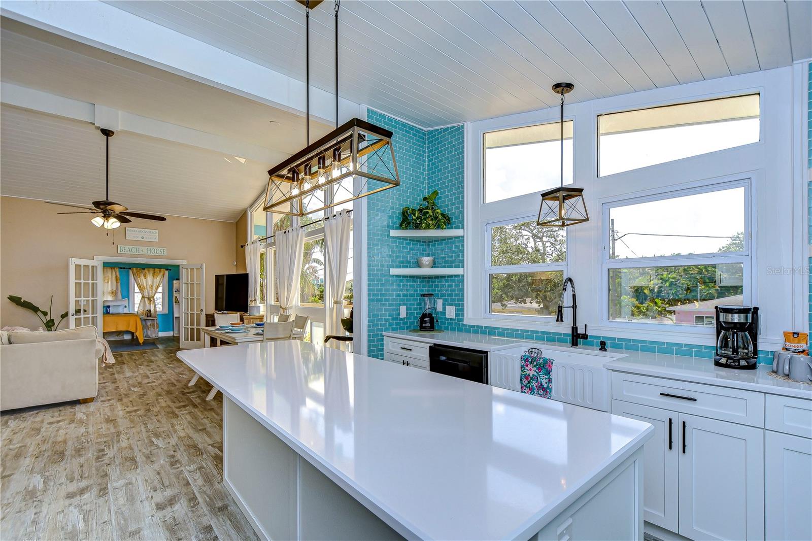 Plenty of counter space in the kitchen, and the large windows are perfect for enjoying sunsets while commingling with the family in the living room