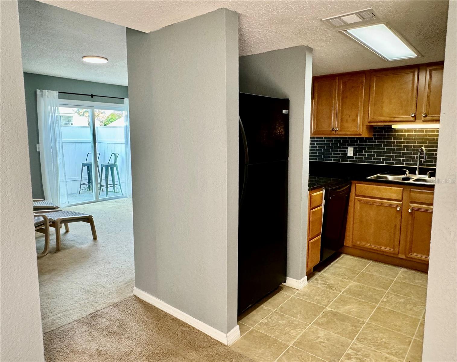 Kitchen with View of Family Room and back patio