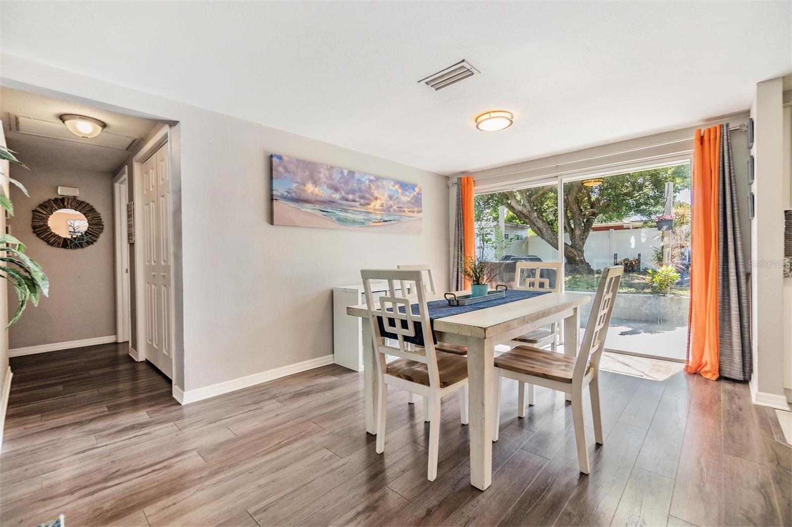 In the dining room has a large sliding glass door that opens to the large fenced back yard