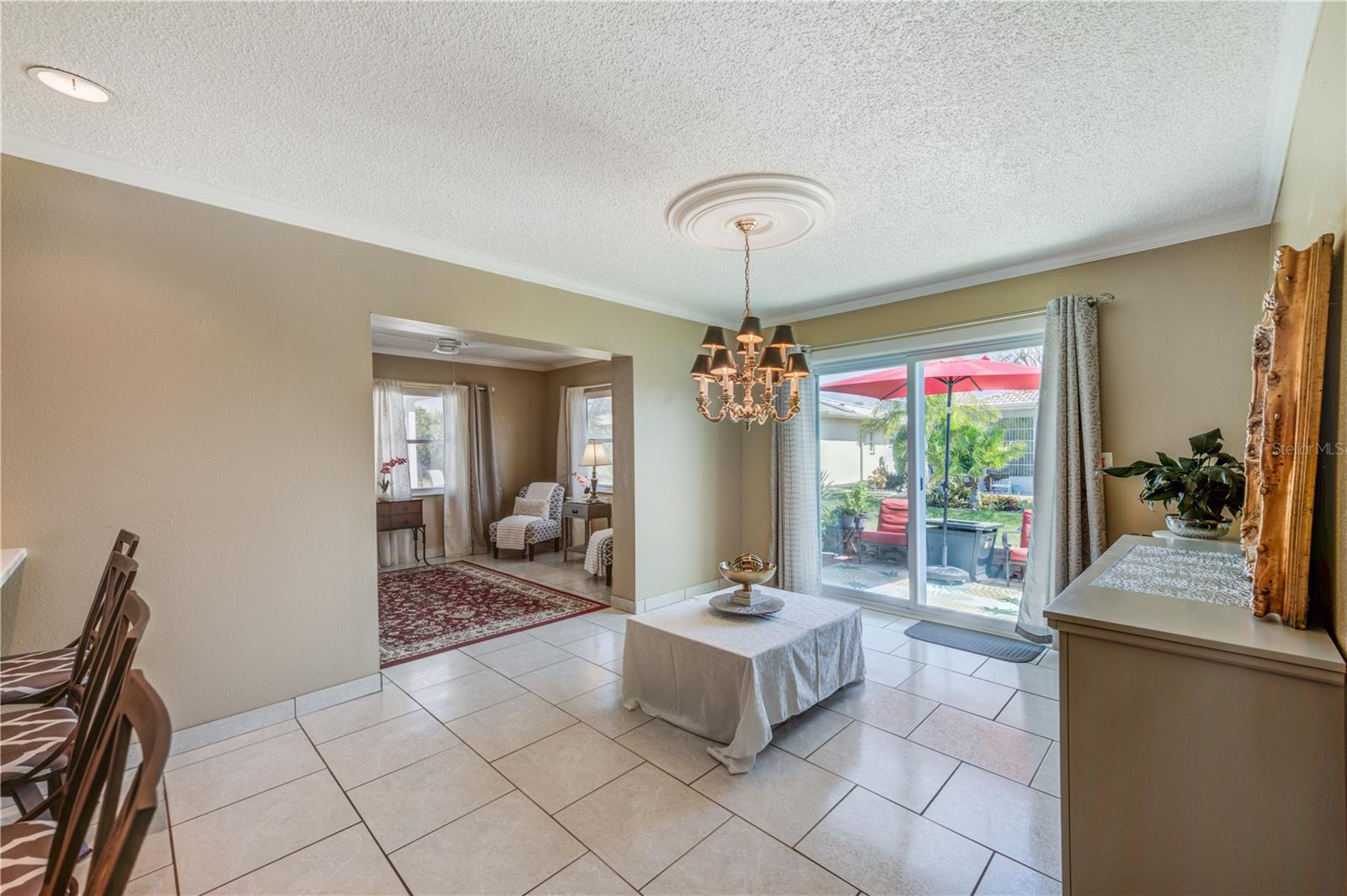 OPEN FLOOR PLAN WITH KITCHEN/DINING AREA/DEN OVERLOOKING THE PATIO