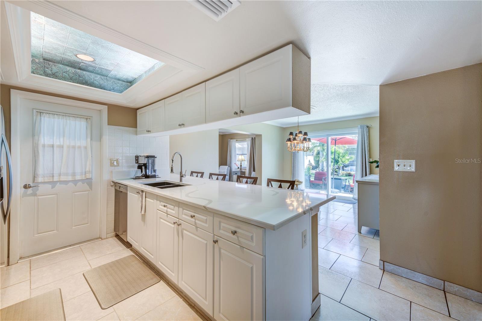 KITCHEN WITH LARGE QUARTZ ISLAND