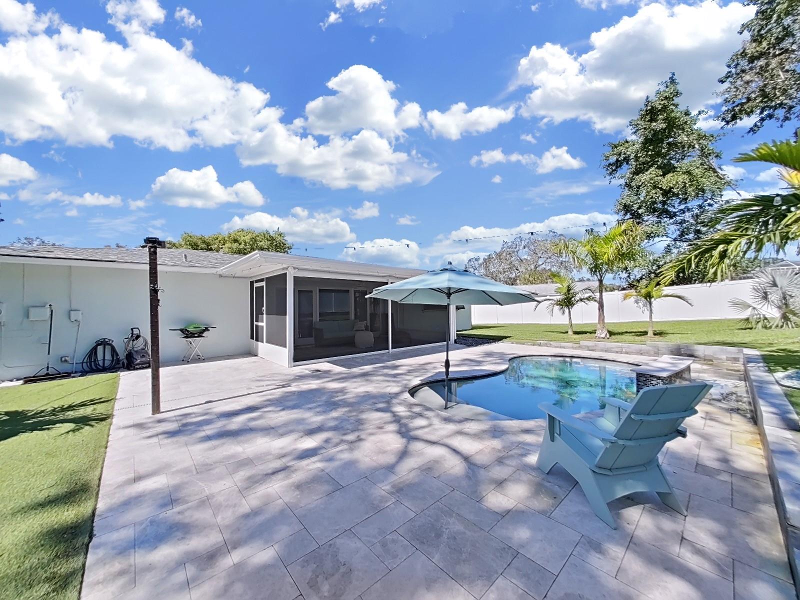 Heated and/or chilled Saltwater pool with waterfall! Surrounded with beautiful travertine tile