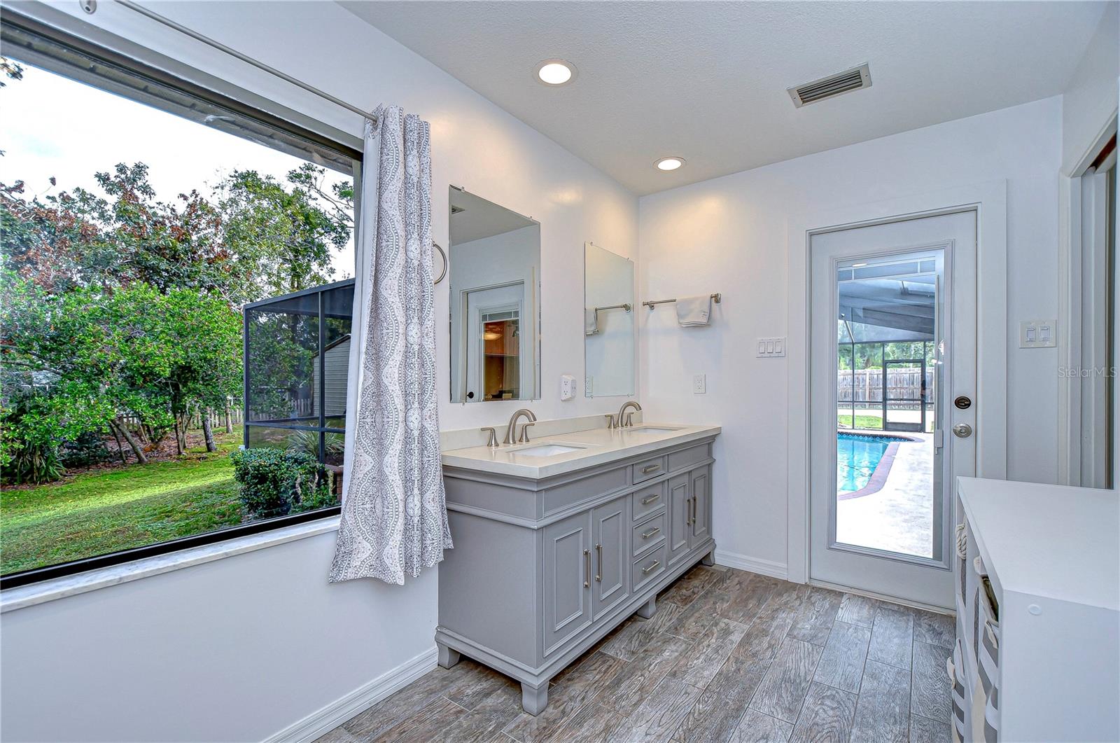 Dual sinks and new hurricane door with enclosed blinds that leads to the pool!