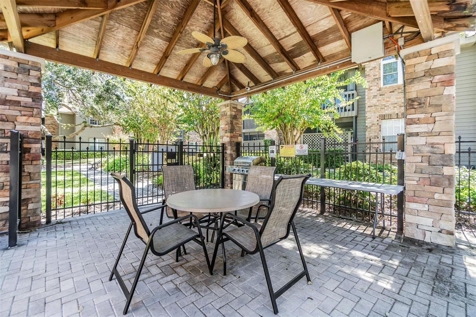 Covered BBQ area by pool.