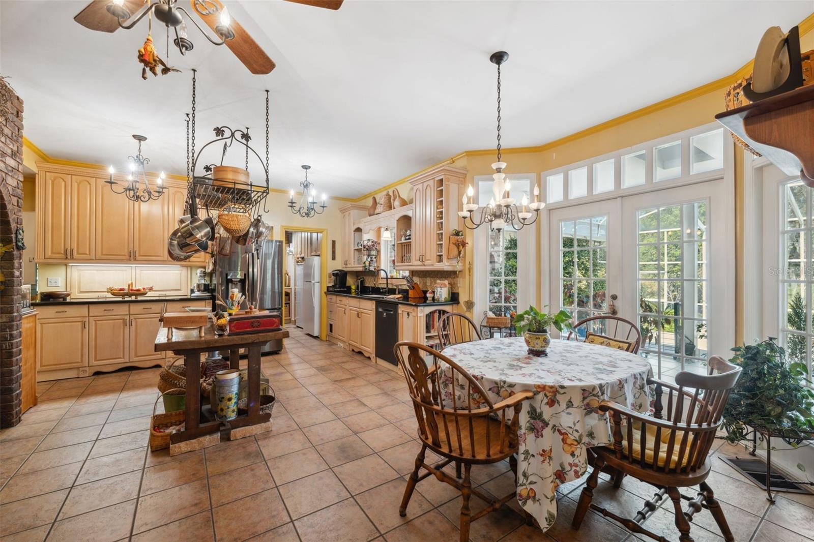 The gourmet kitchen overlooks the backyard and gardens through French doors.