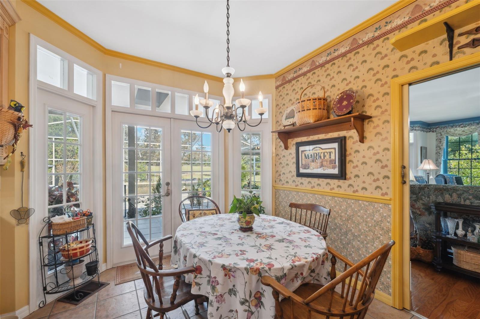 Dining area in kitchen with French doors to the backyard and gardens. The kitchen and den flow nicely together through a set of double doors.