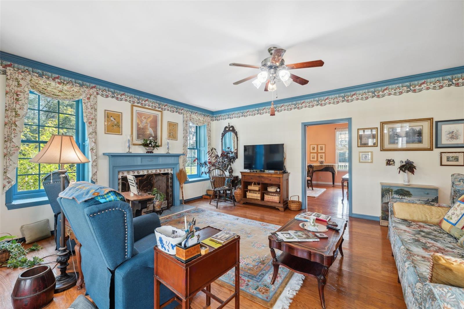 Another view of the den with gorgeous windows and fireplace.