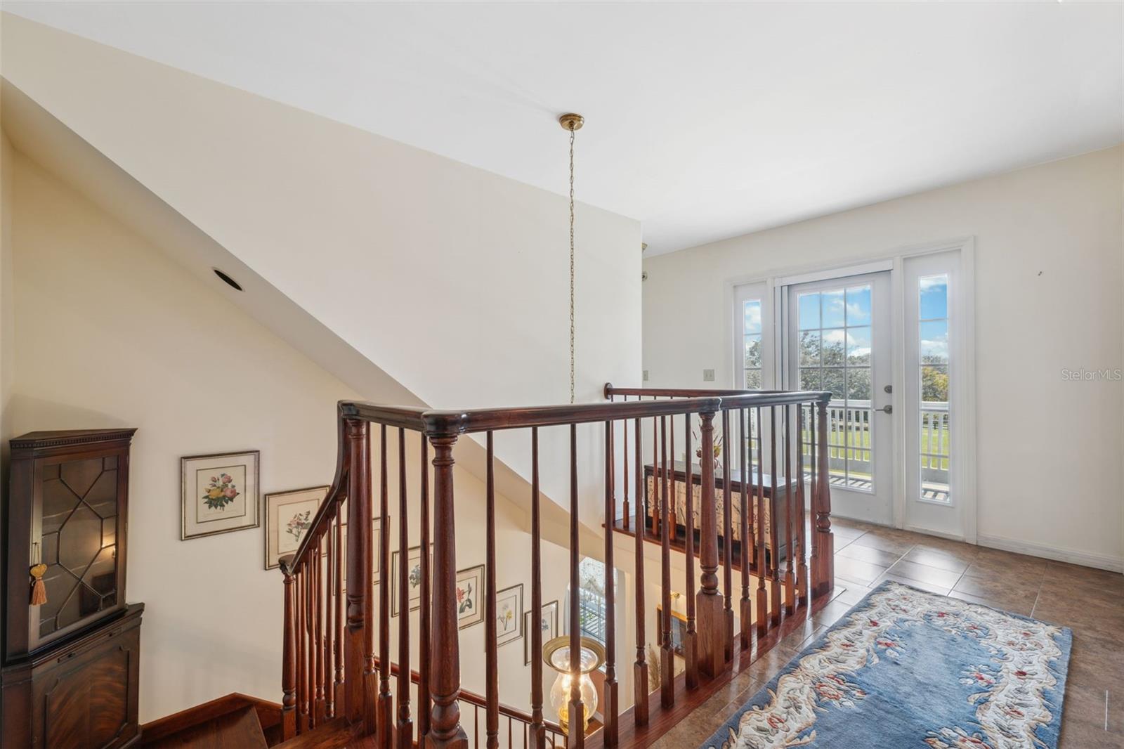 Top landing on the second level. Notice the door leading to the front balcony. Gorgeous views! Home also has a third set of butler stairs for optimal convenience.