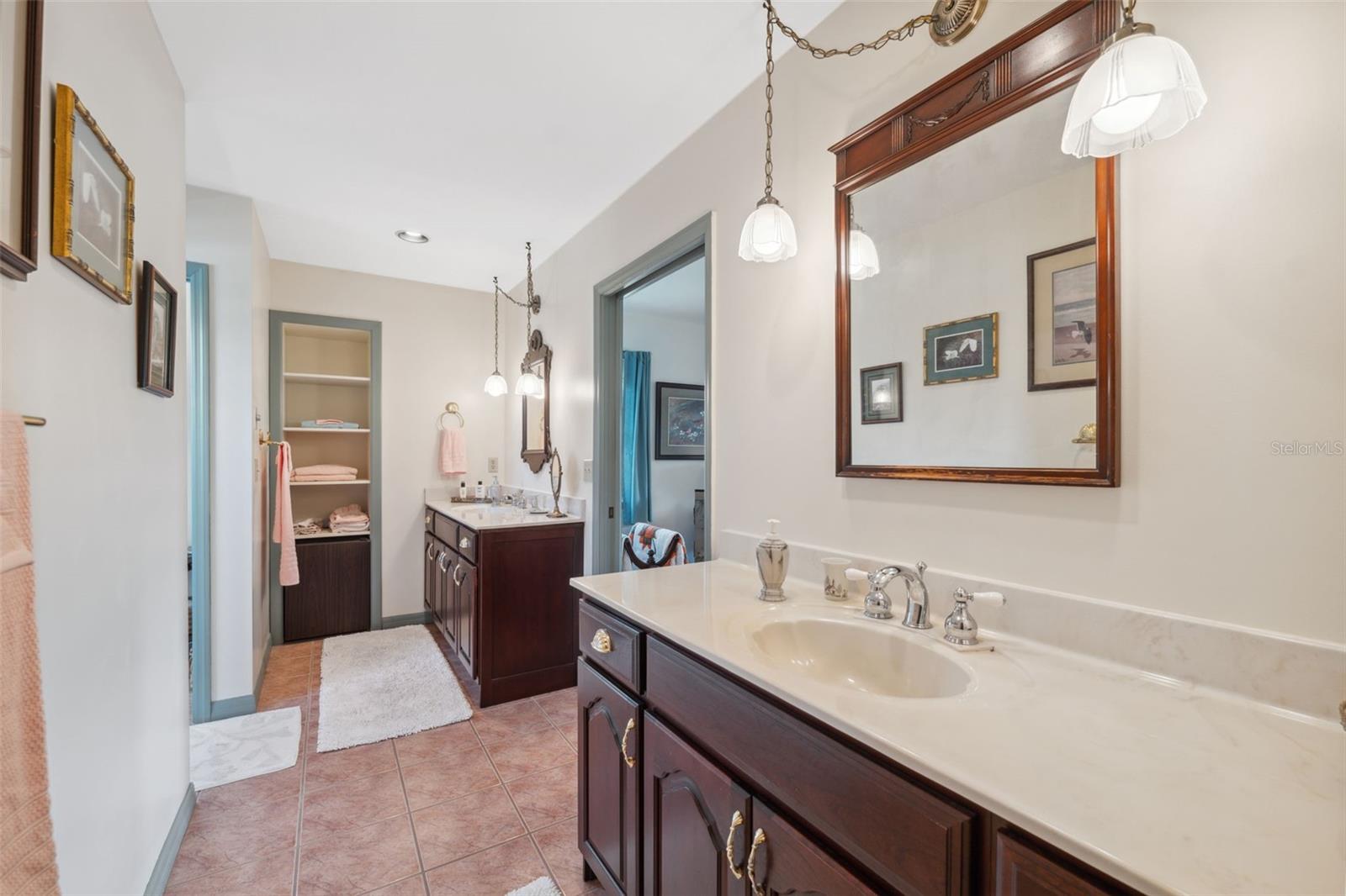 The primary suite bath has double vanities with extra closet and storage space.