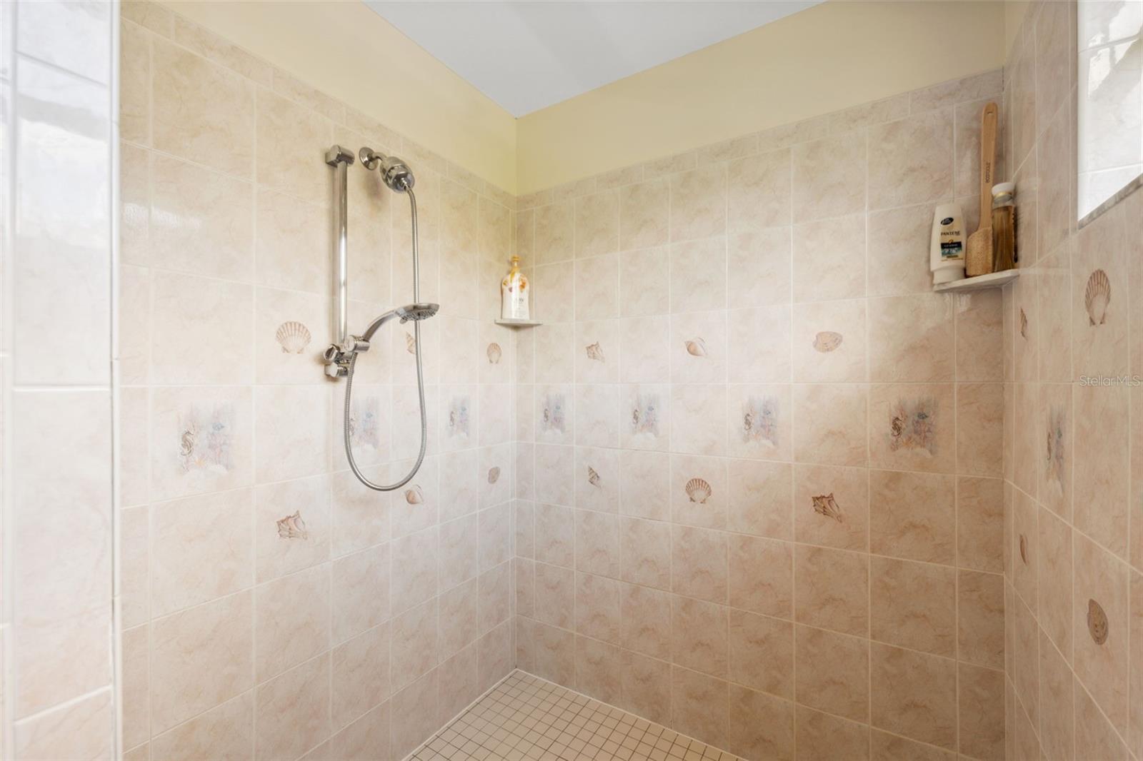 Walk-in shower for primary suite.