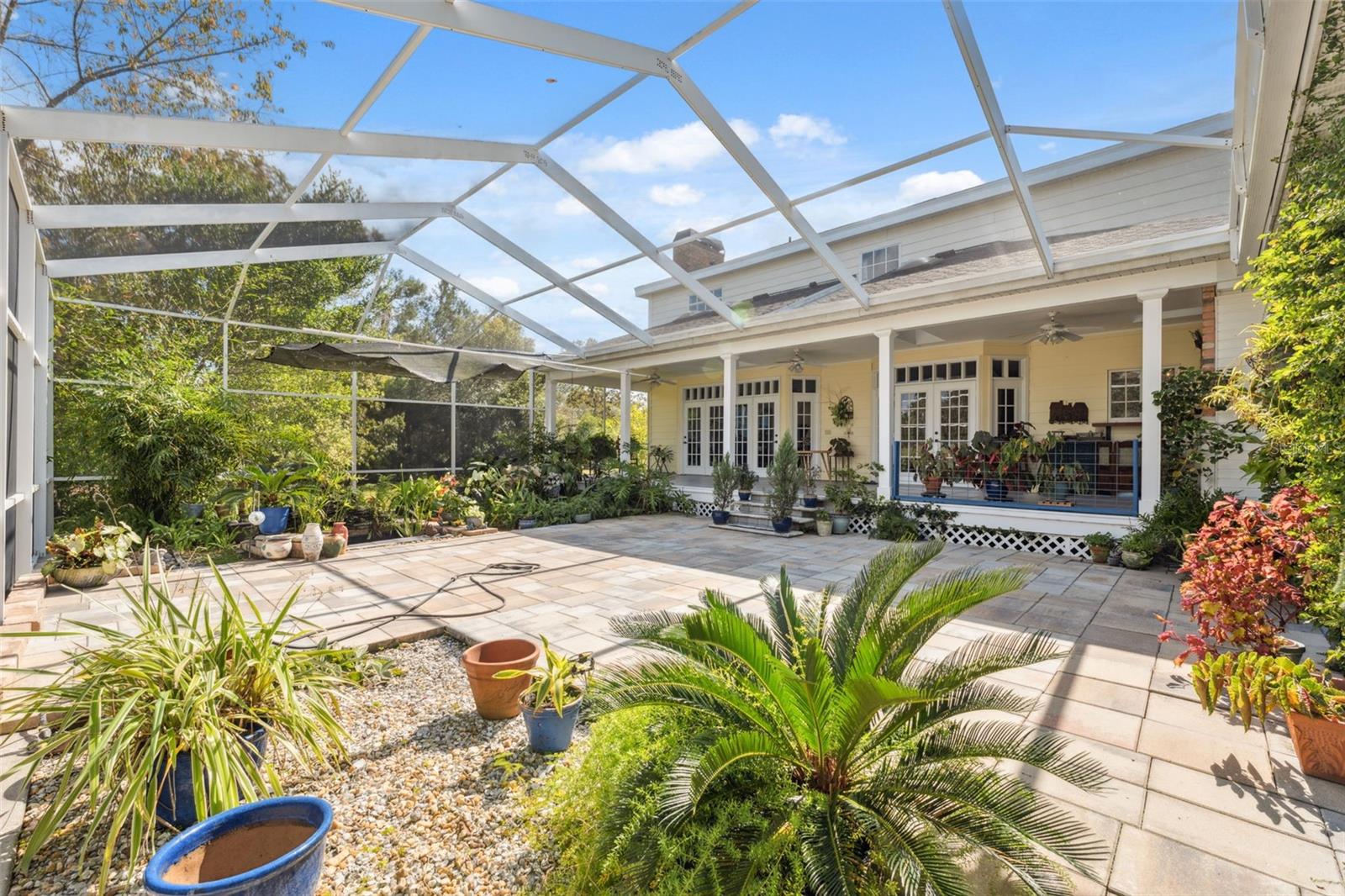 The rear porch flows nicely into the spacious lanai. Perfect for those outdoor gatherings. Offers privacy and more great views of the property.