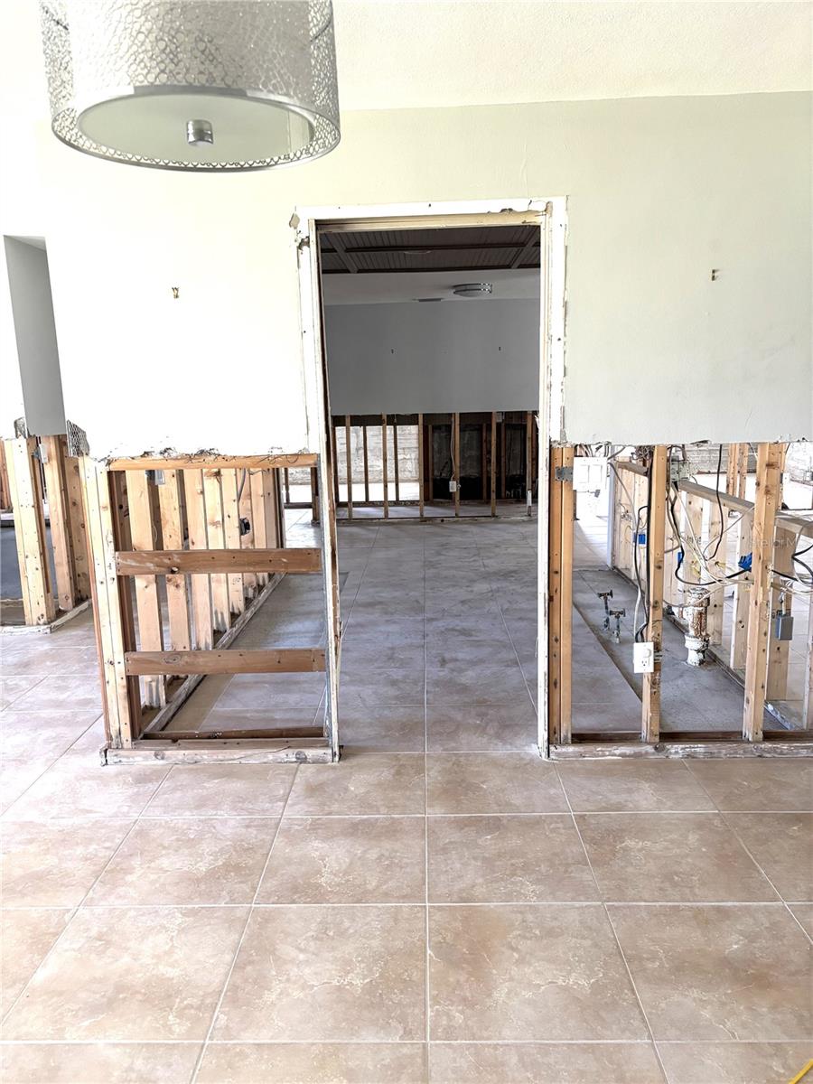 Dining room next to the living room and foyer, overlooking the kitchen