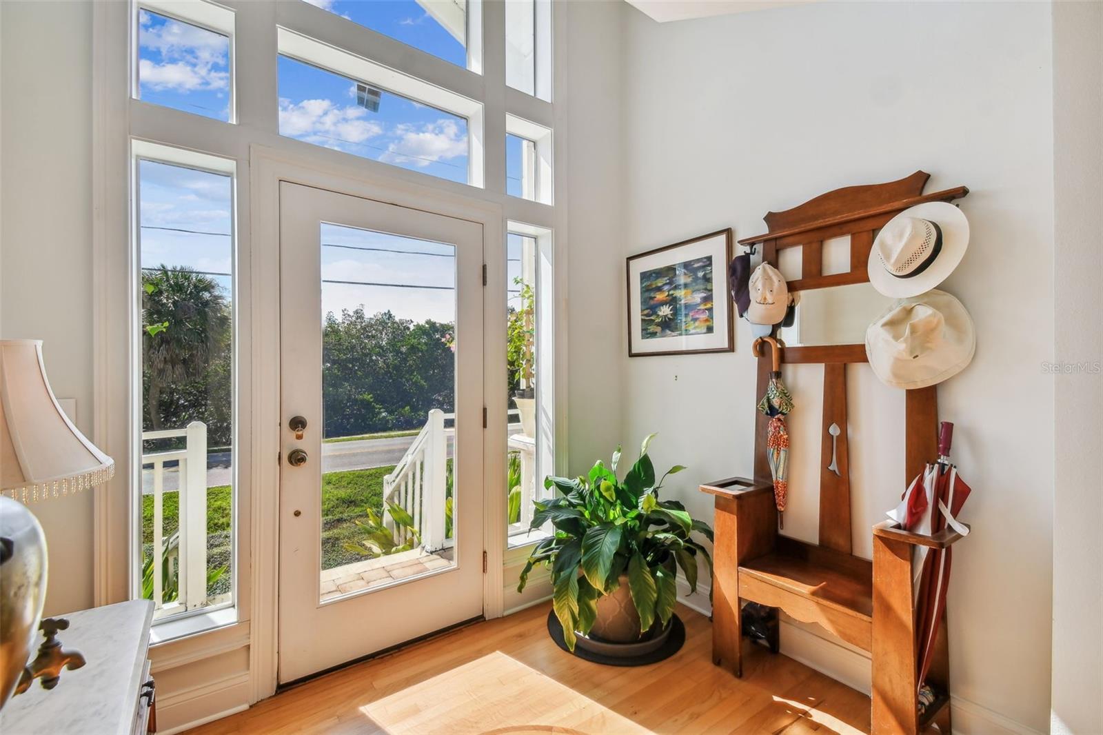 The bright and light beautifully designed Foyer plus a view of all new wood floors the Buyer sees throughout the extensive home renovation 2 yrs ago!