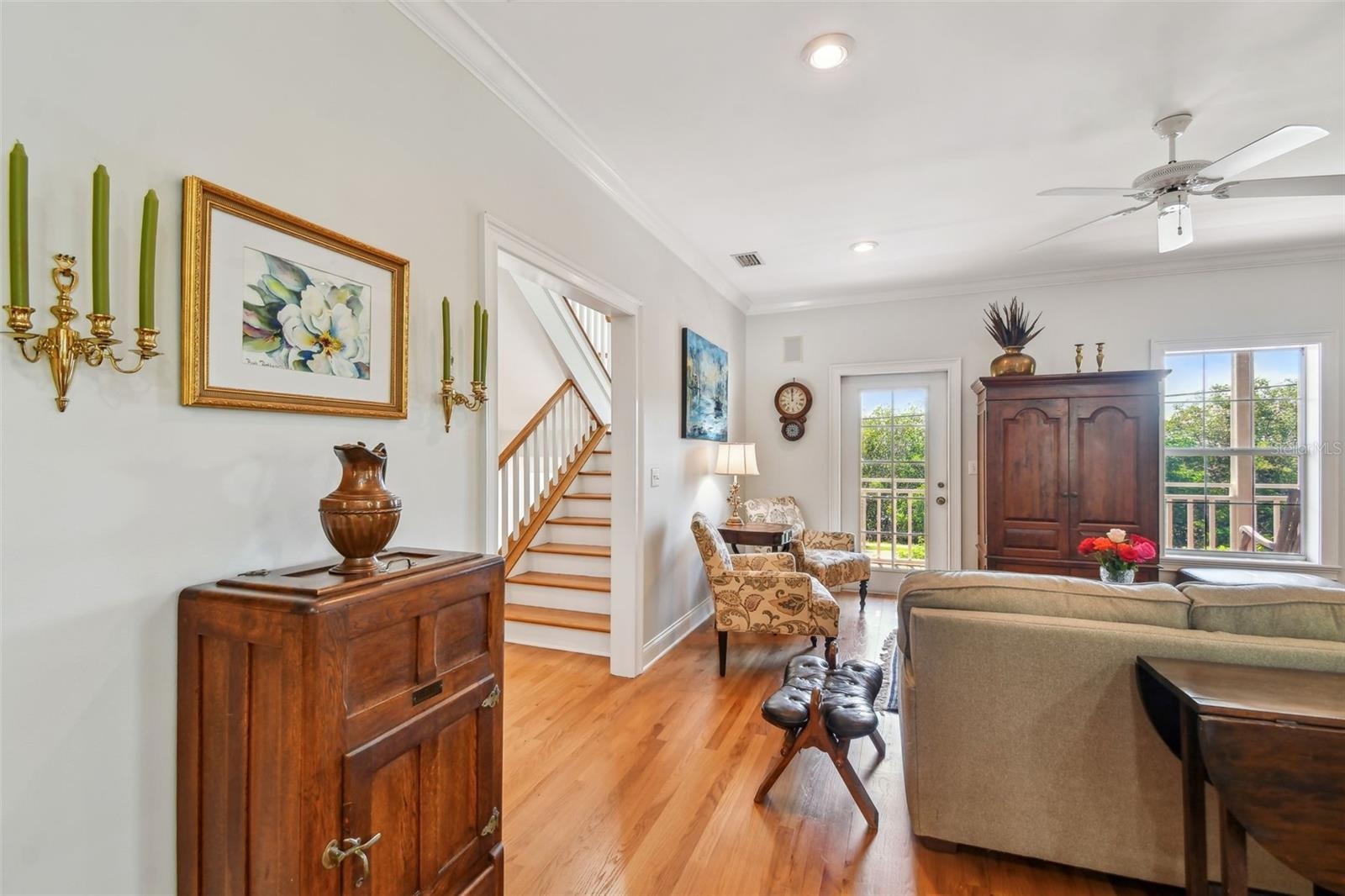 View from the Kitchen of the beautiful 2 years new wood floors, lovely view of the Staircase to the 3rd floor bedrooms, Family Room window and door to the extensive covered porch