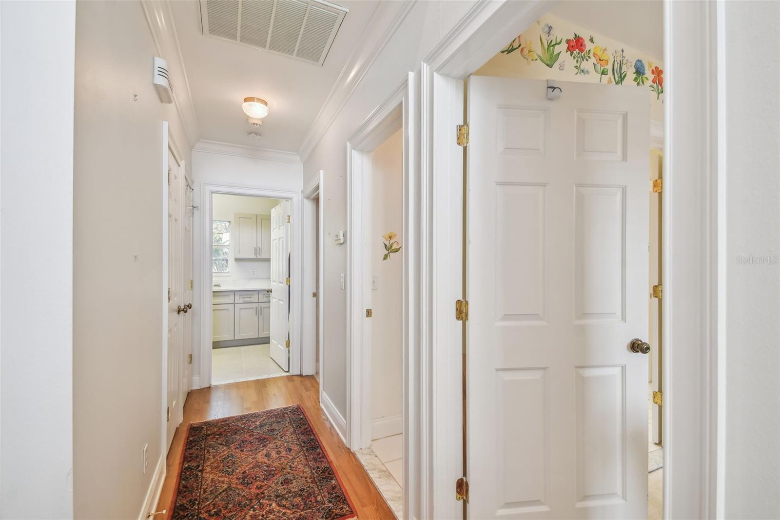 3rd floor Hallway w/ Storage, Master Suite to the left, Laundry Room in background, 2 BR on right w/ Bath designed for privacy