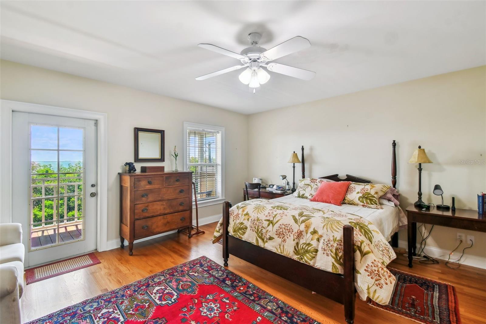 The bright room w/ a window and a door to the private porch deck