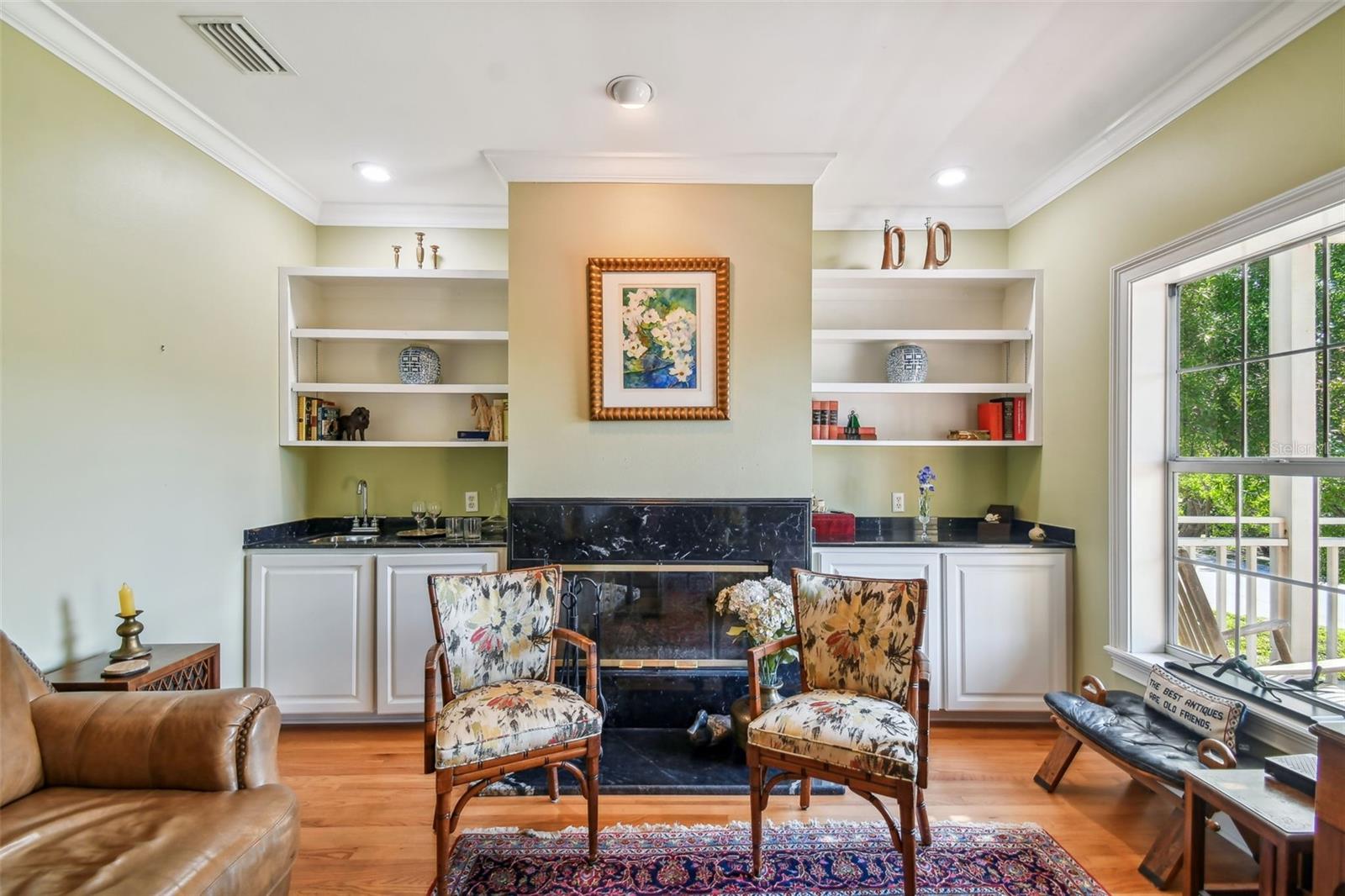 The bright Living Room with a window and a door to the private porch with the partial Bay view for entertaining!