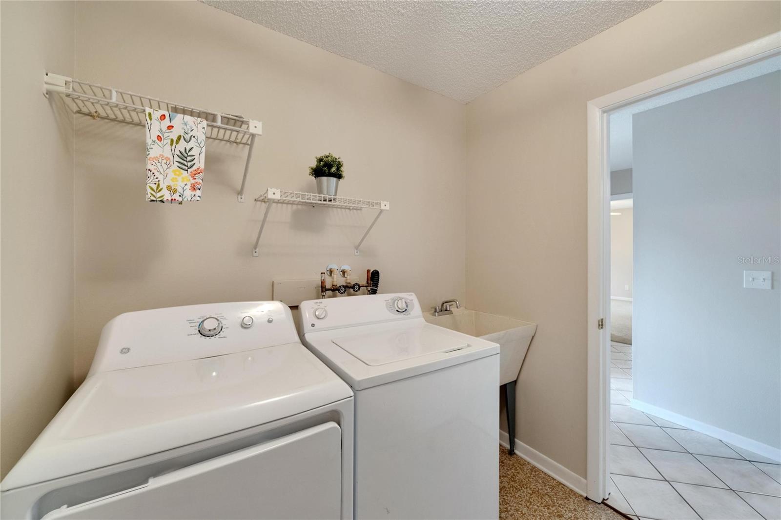 laundry room leading to 2 car garage