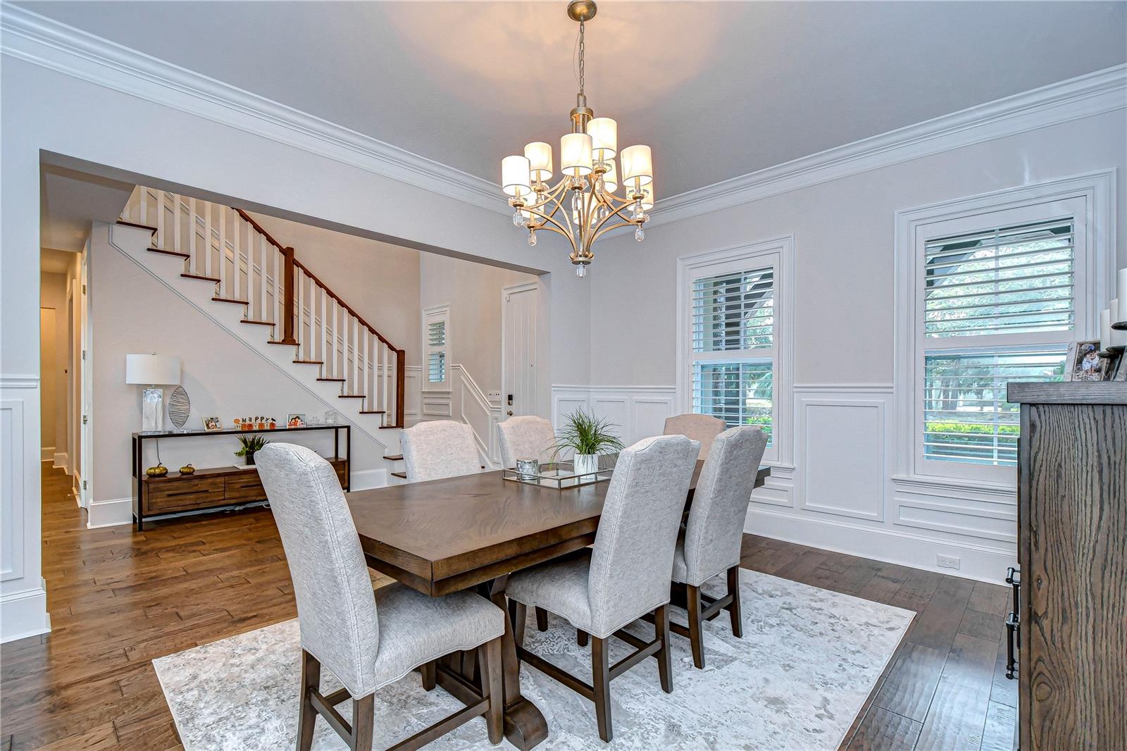 Elegant crown molding, custom wainscoting, and a convenient dry bar!