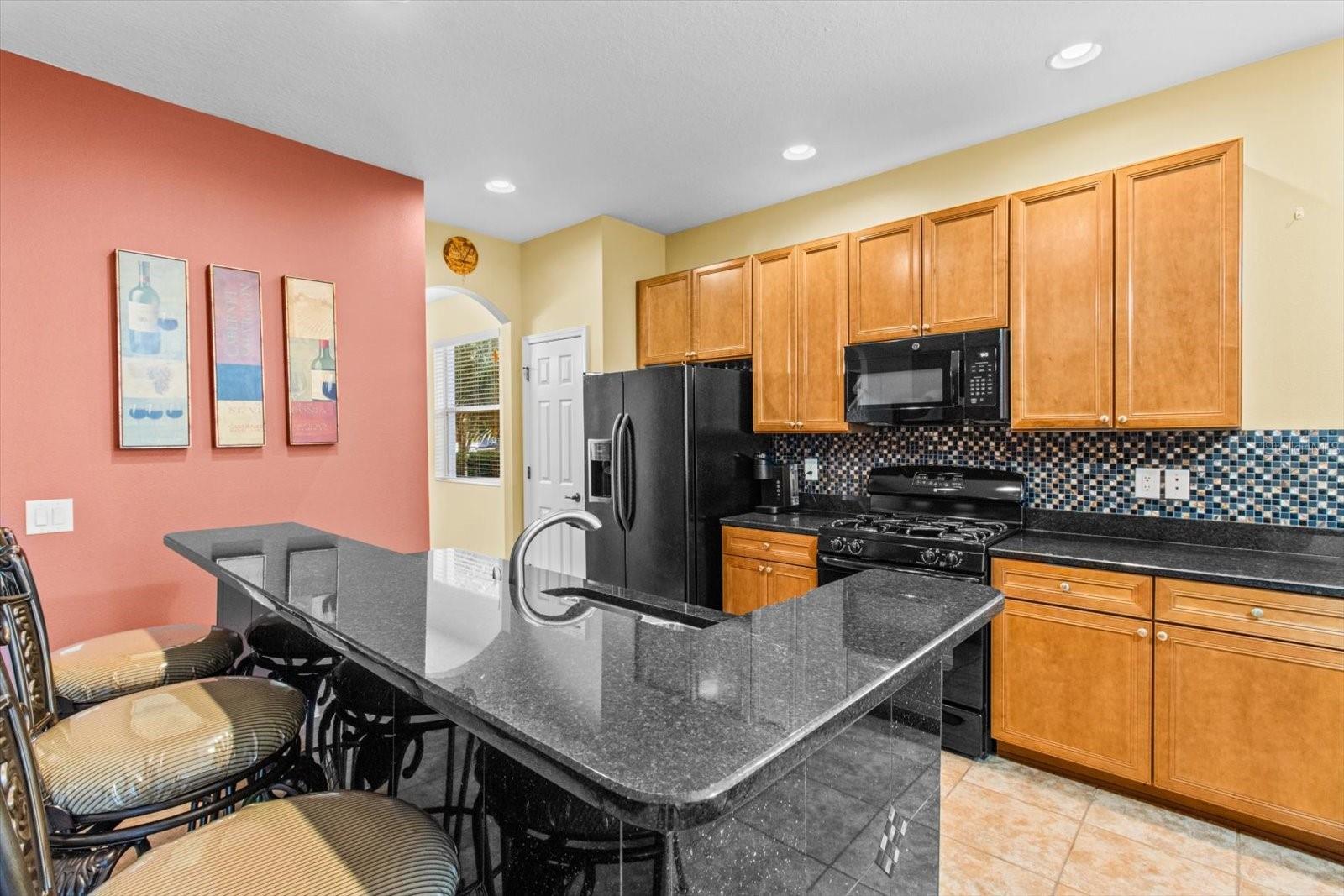 Kitchen and High Top Breakfast Bar with Marble Accents