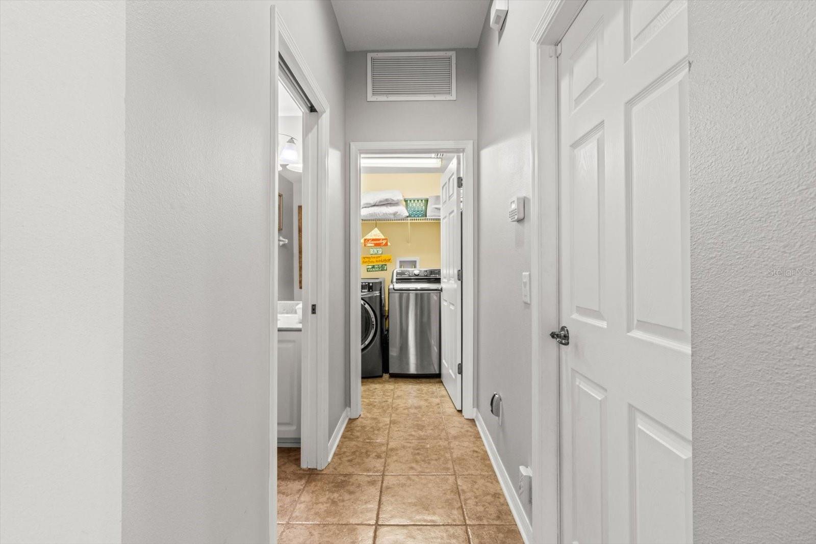 Downstairs Hallway from Garage Leading to Laundry Room and Main Floor Half Bath