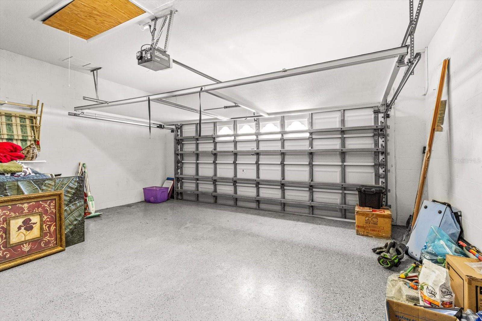 Two Car Garage has 'Screen' to and Pull Down Storage as well as Rack Storage