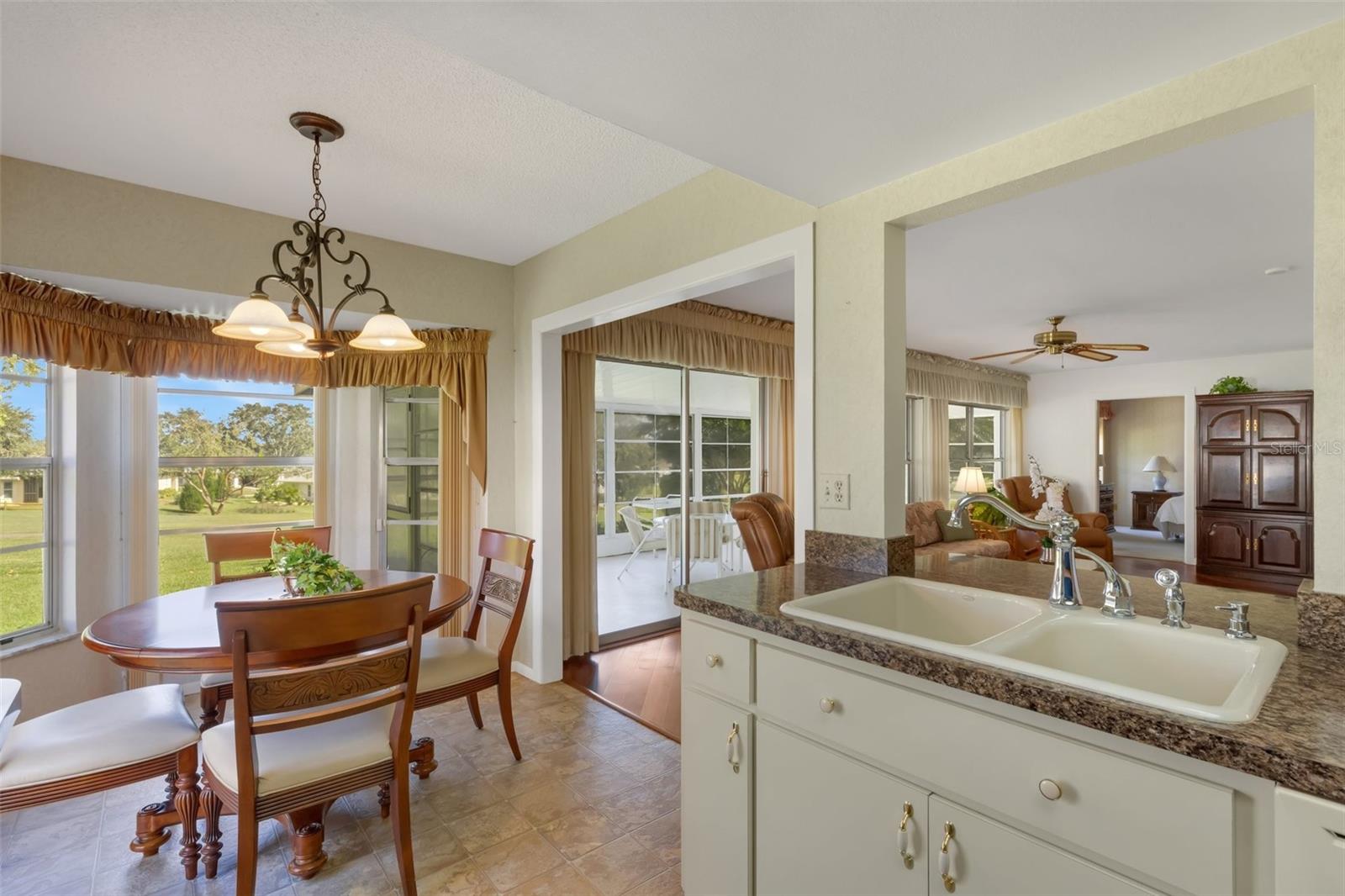 Breakfast nook nicely tucked between endless green golf views & open to expanded family room~