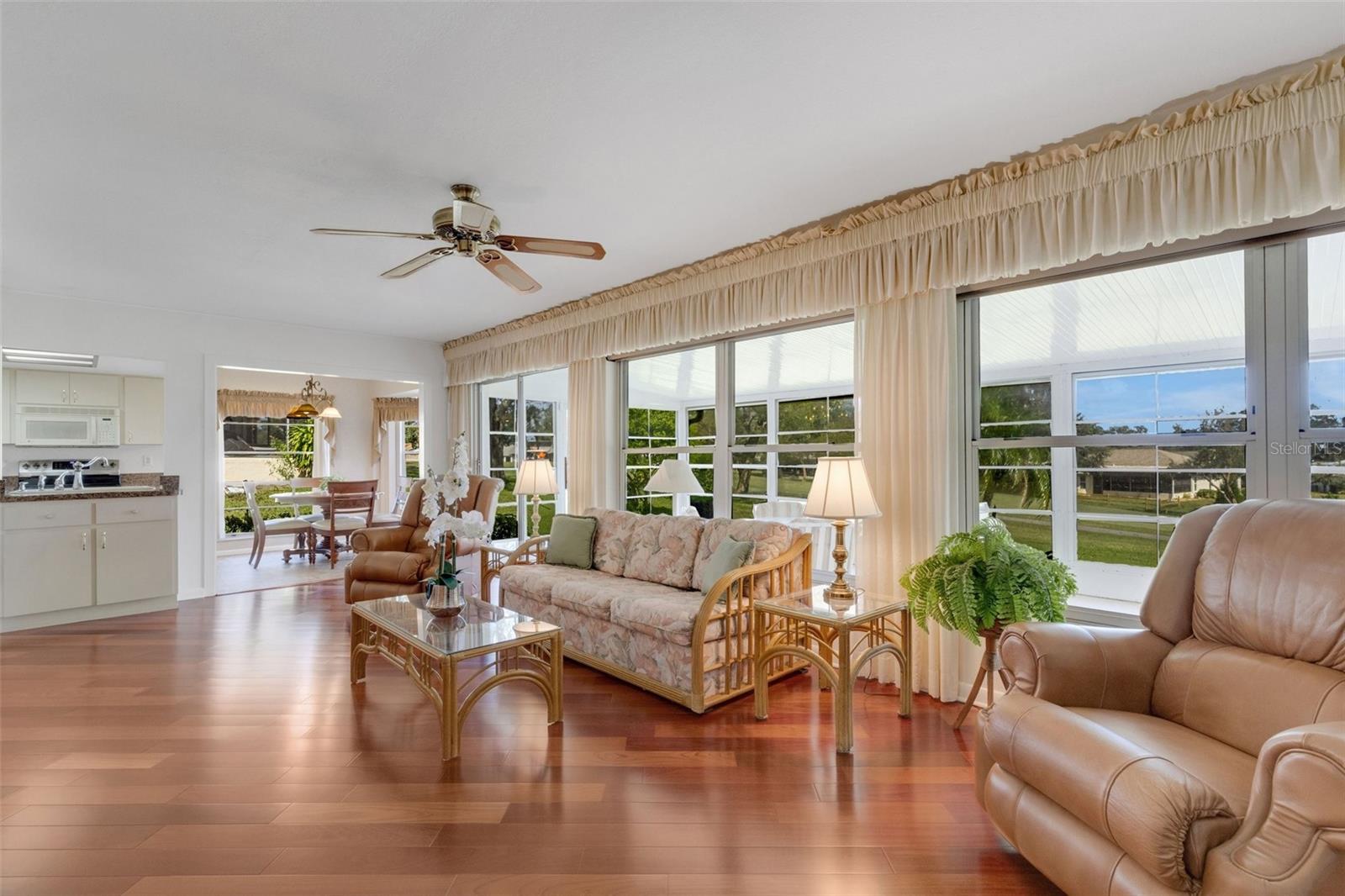 Take in beautiful golf views from oversized family room or go through sliders to enclosed sunroom~