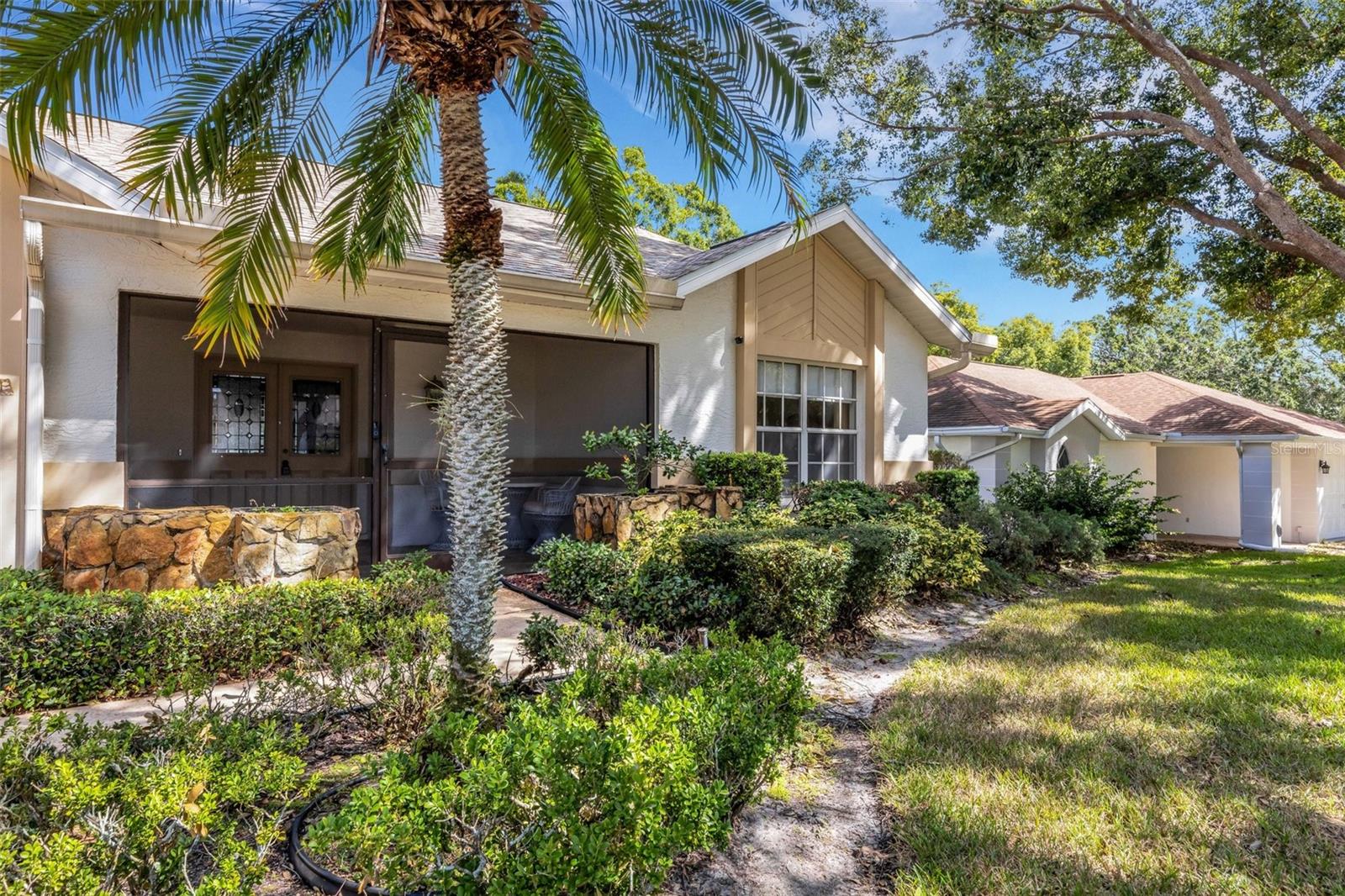 Screened front porch with a gracious double door entry~