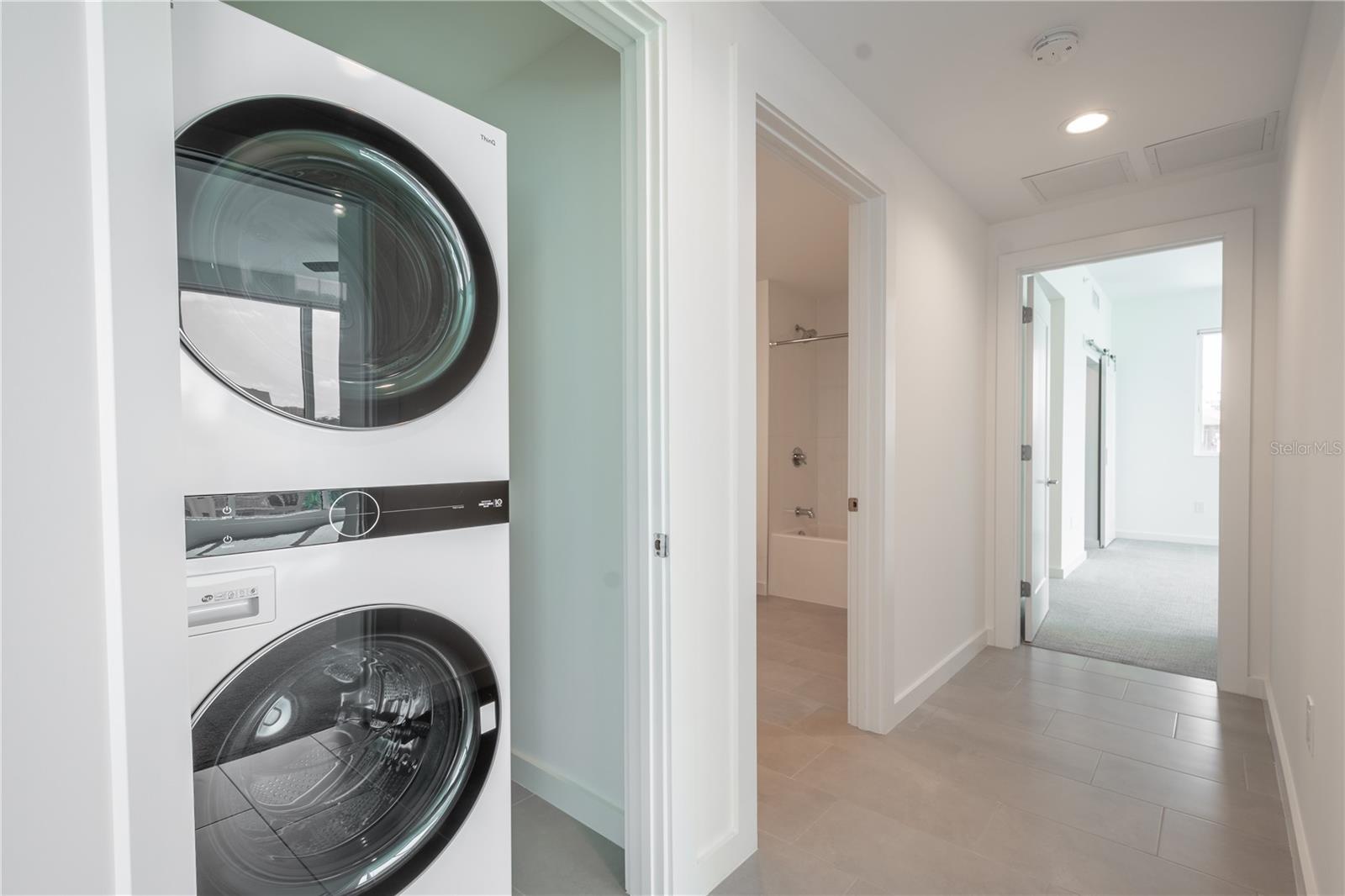 The unit features a stackable LG washer and dryer.