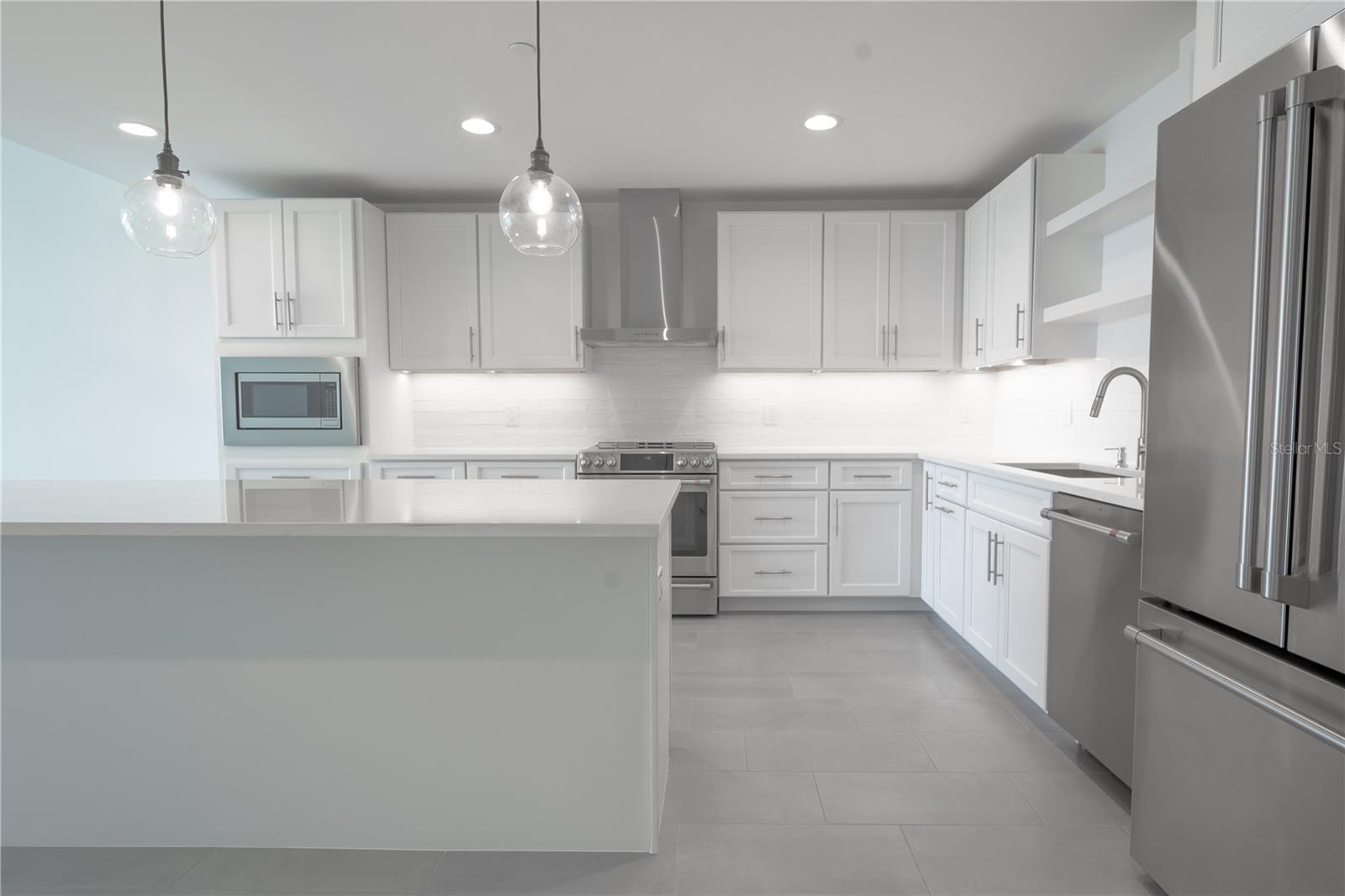 A modern Kitchen with a suite of stainless steel Cafe appliances