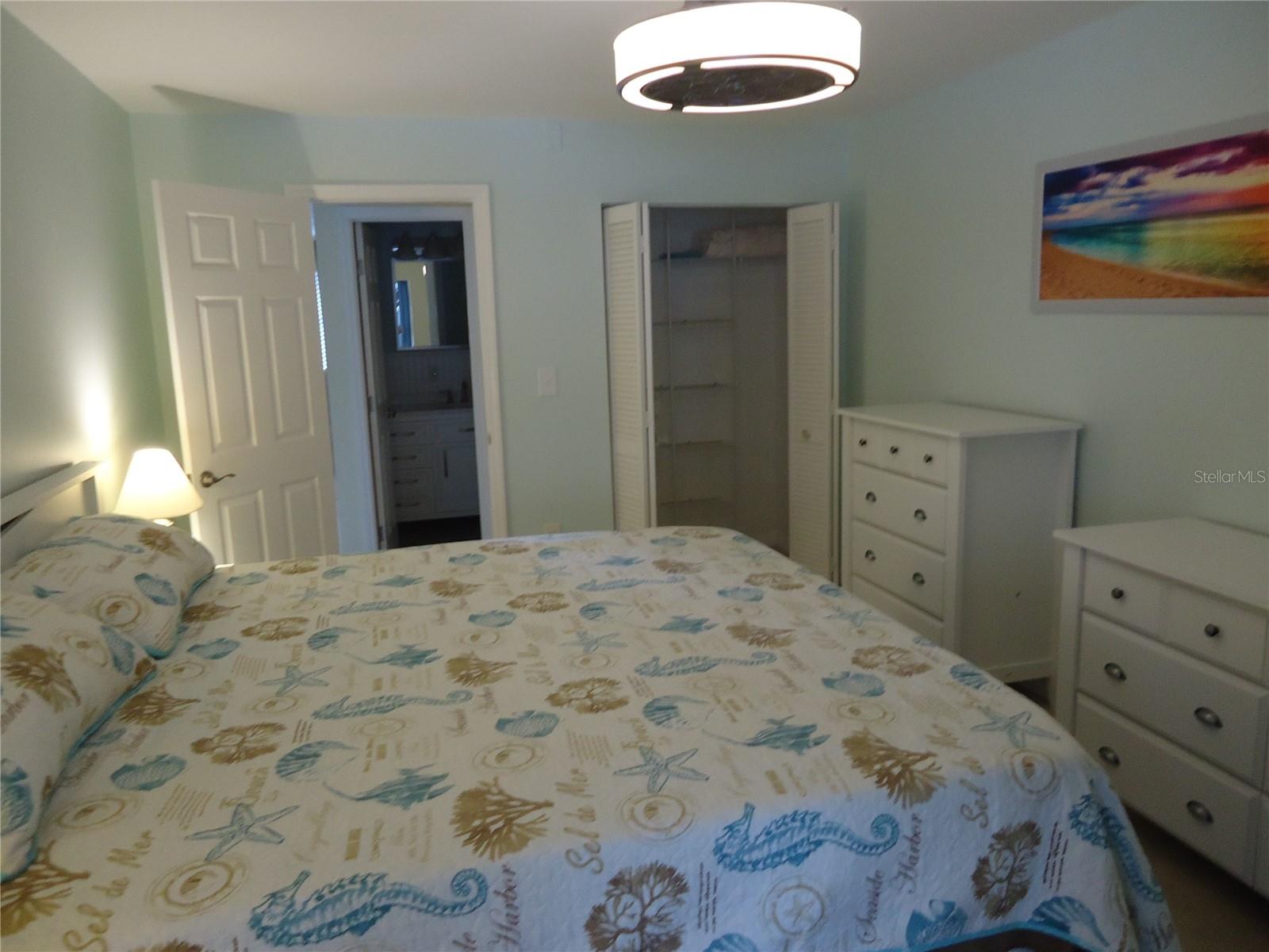 King bed in bedroom with 2 closets