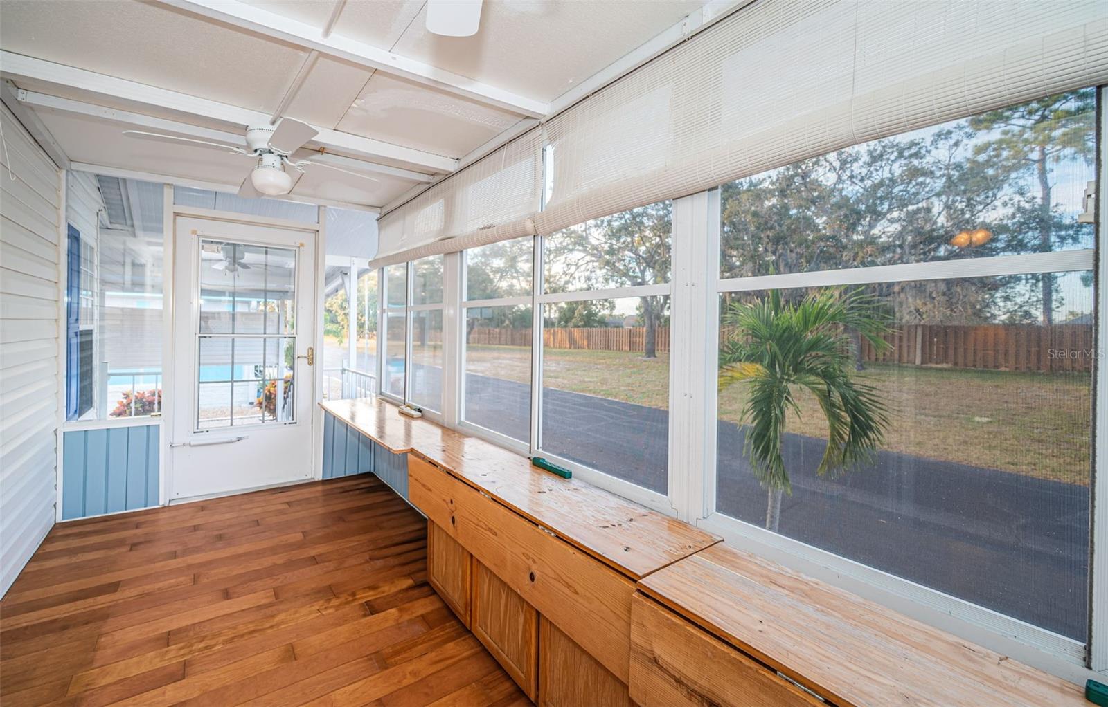 Florida room with wall unit and ceiling fan