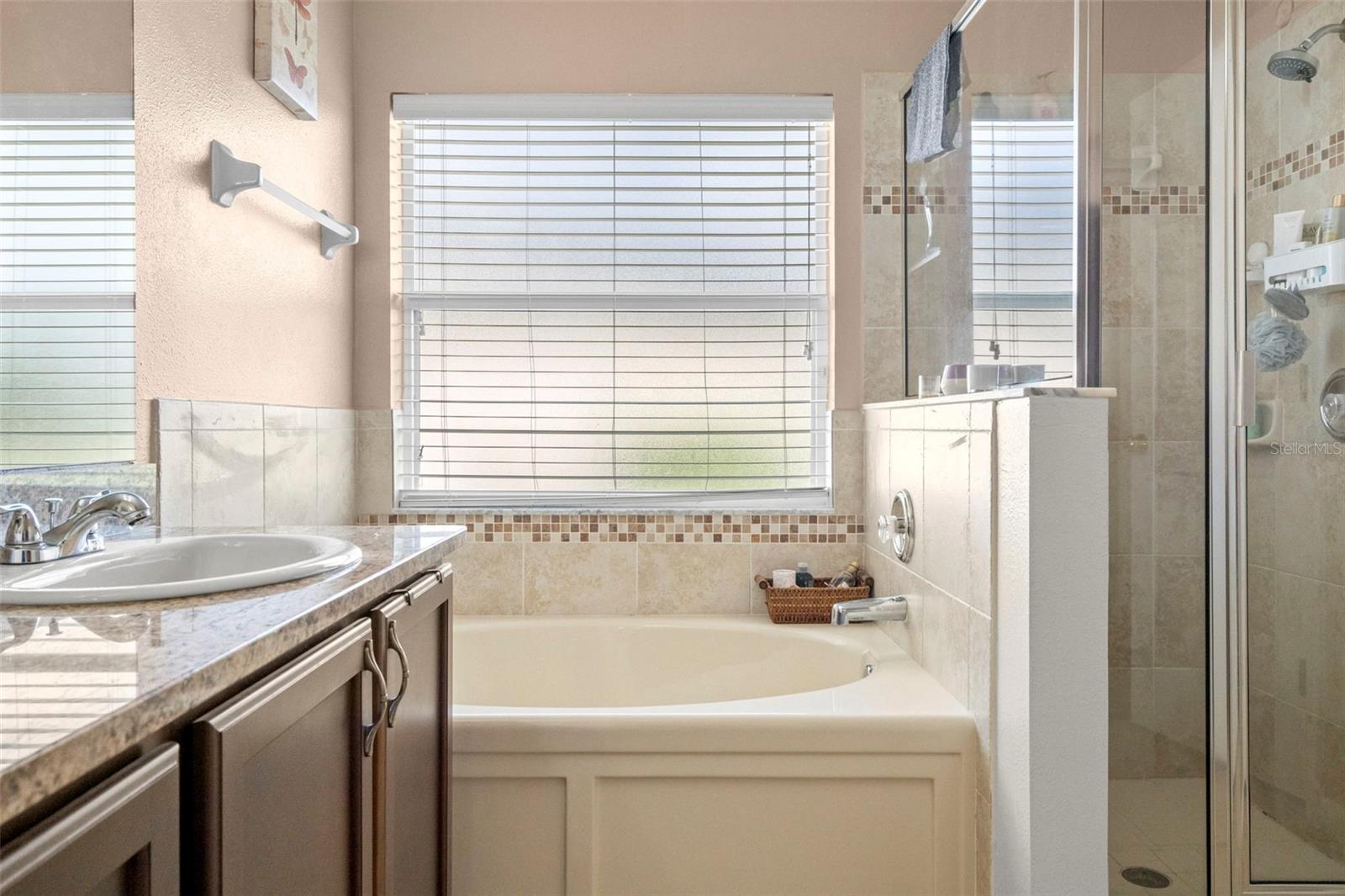 Separate shower and garden tub in primary bathroom