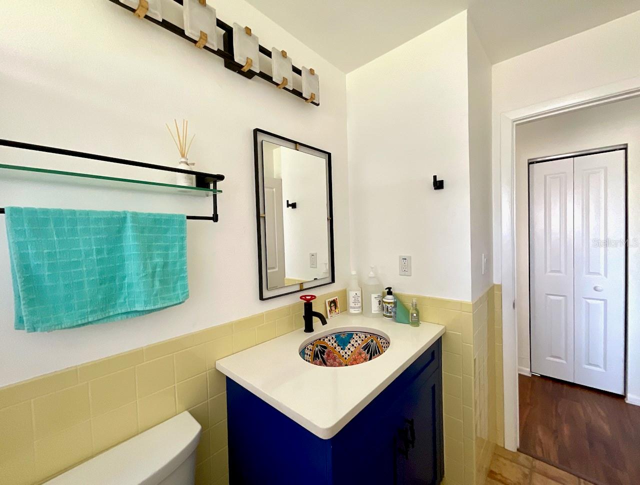 Sink area in guest bath and walk-in closet across the hall