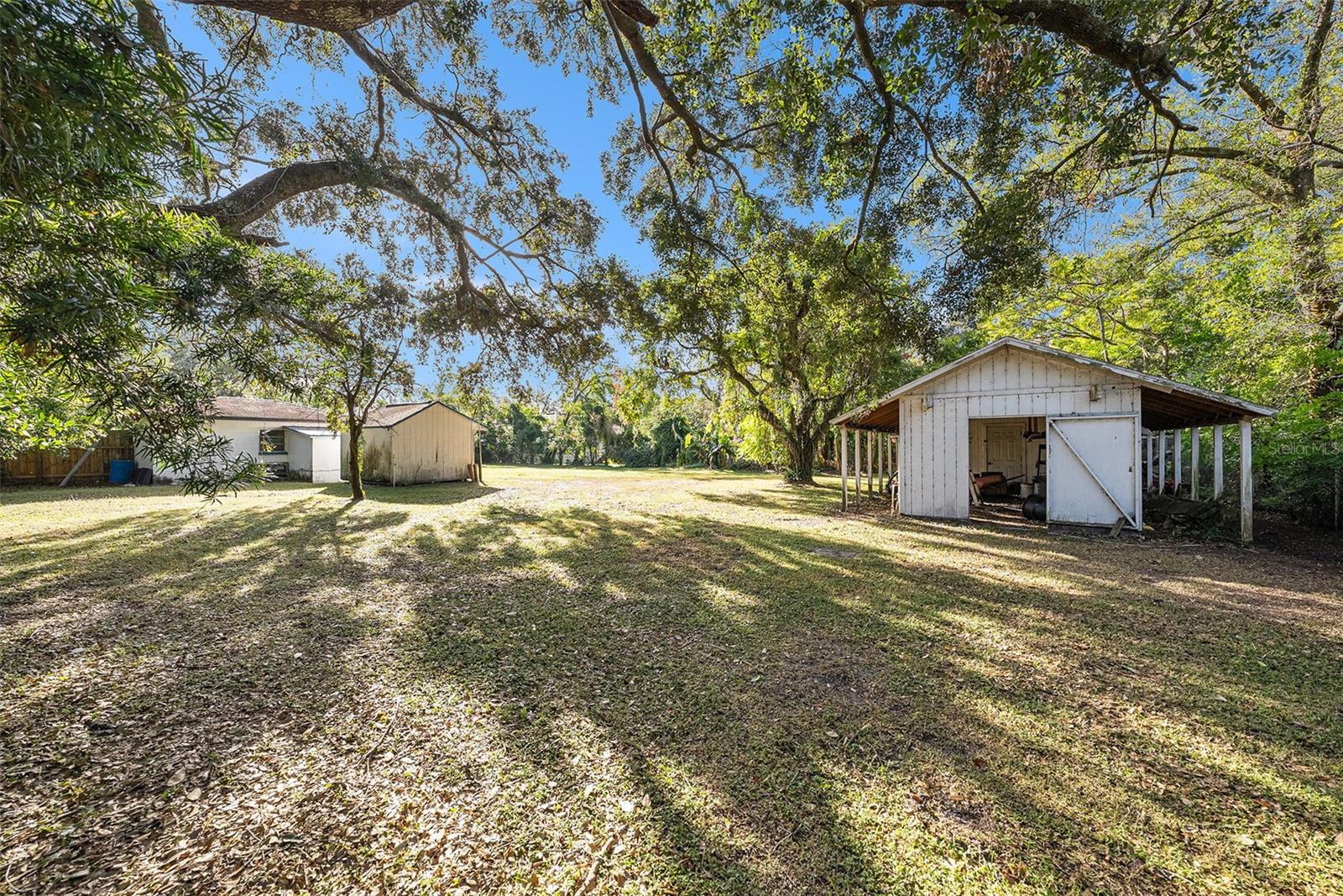 Back Yard with Chicken Coupe Barn, 1 car garage, and storage Shed