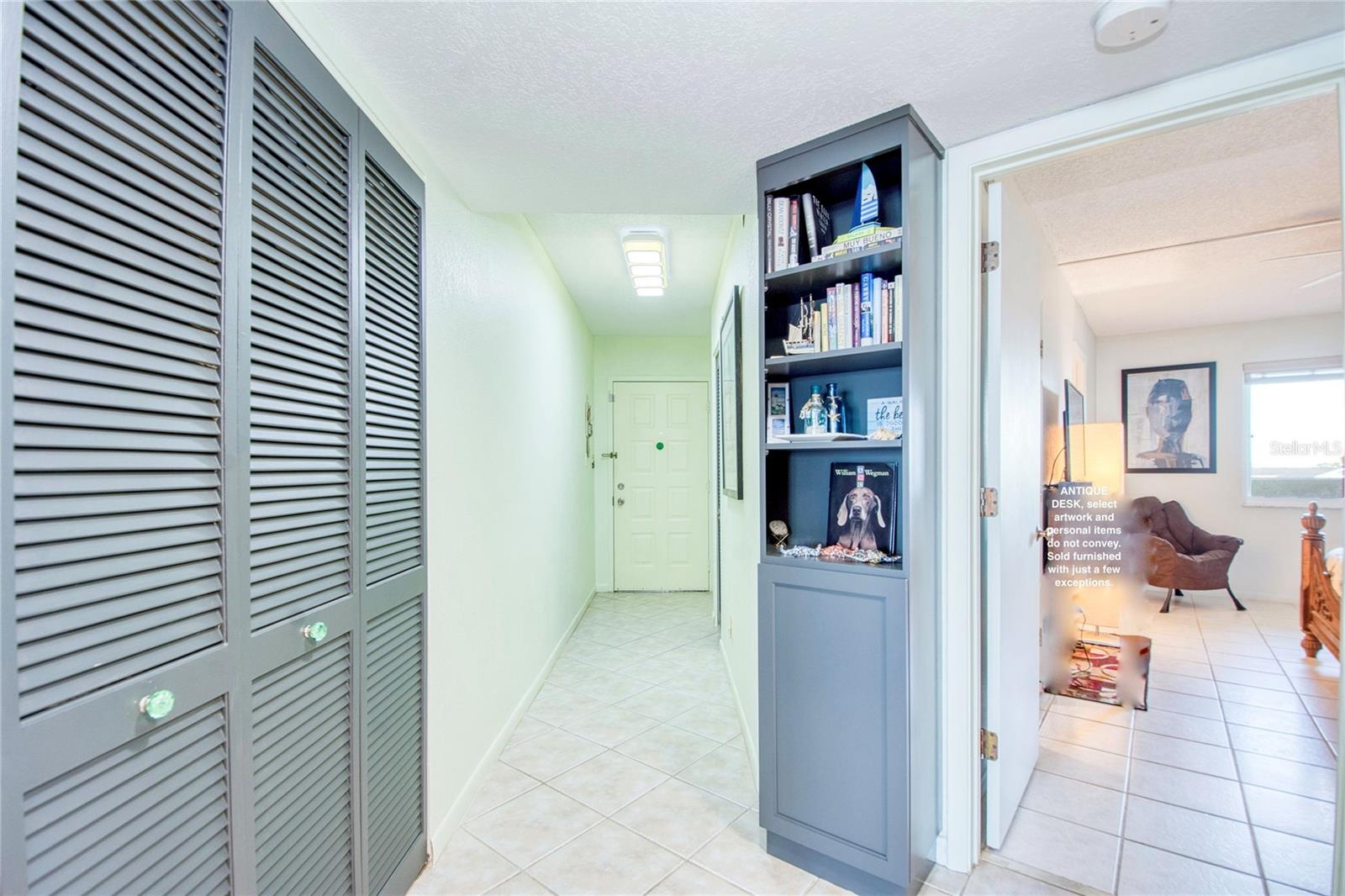 Pantry and foyer entry featuring a coat closet.