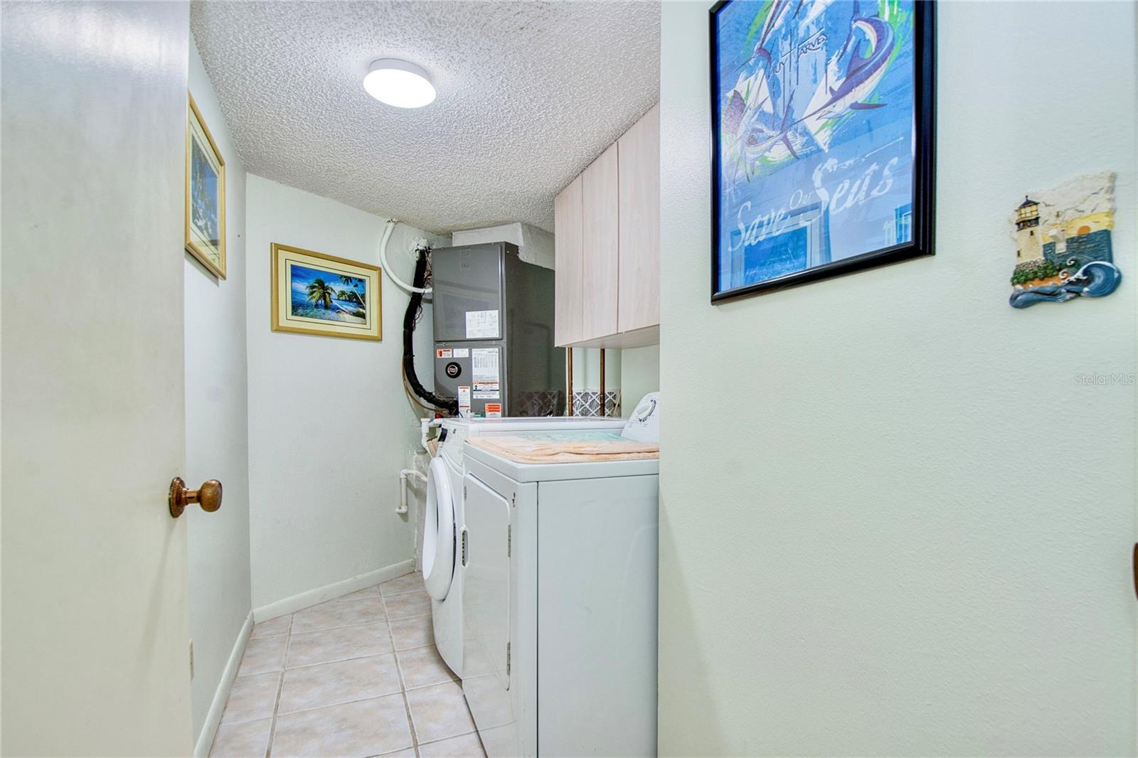 Inside condo interior laundry room.